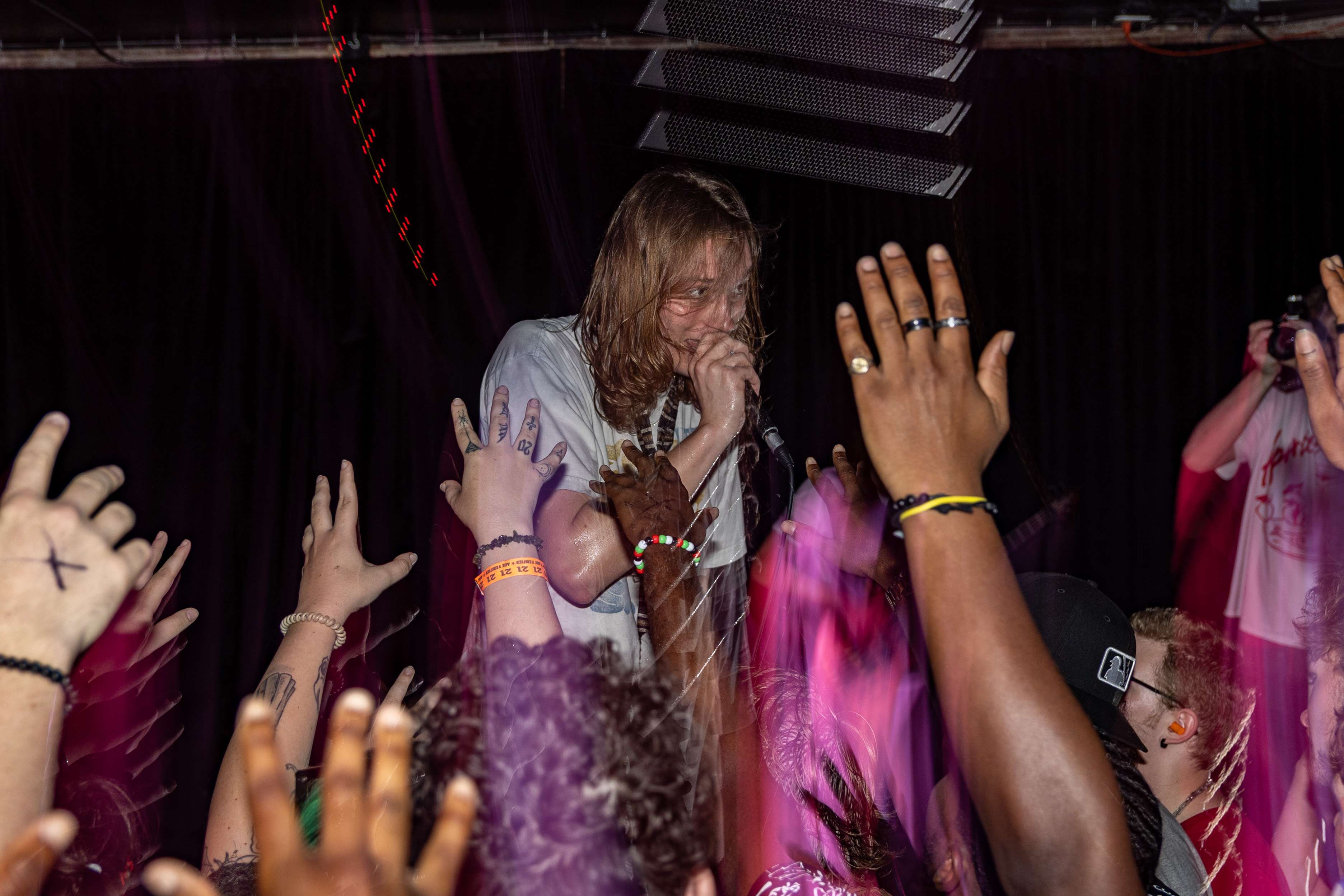 a man with his hands up in the air in front of a crowd