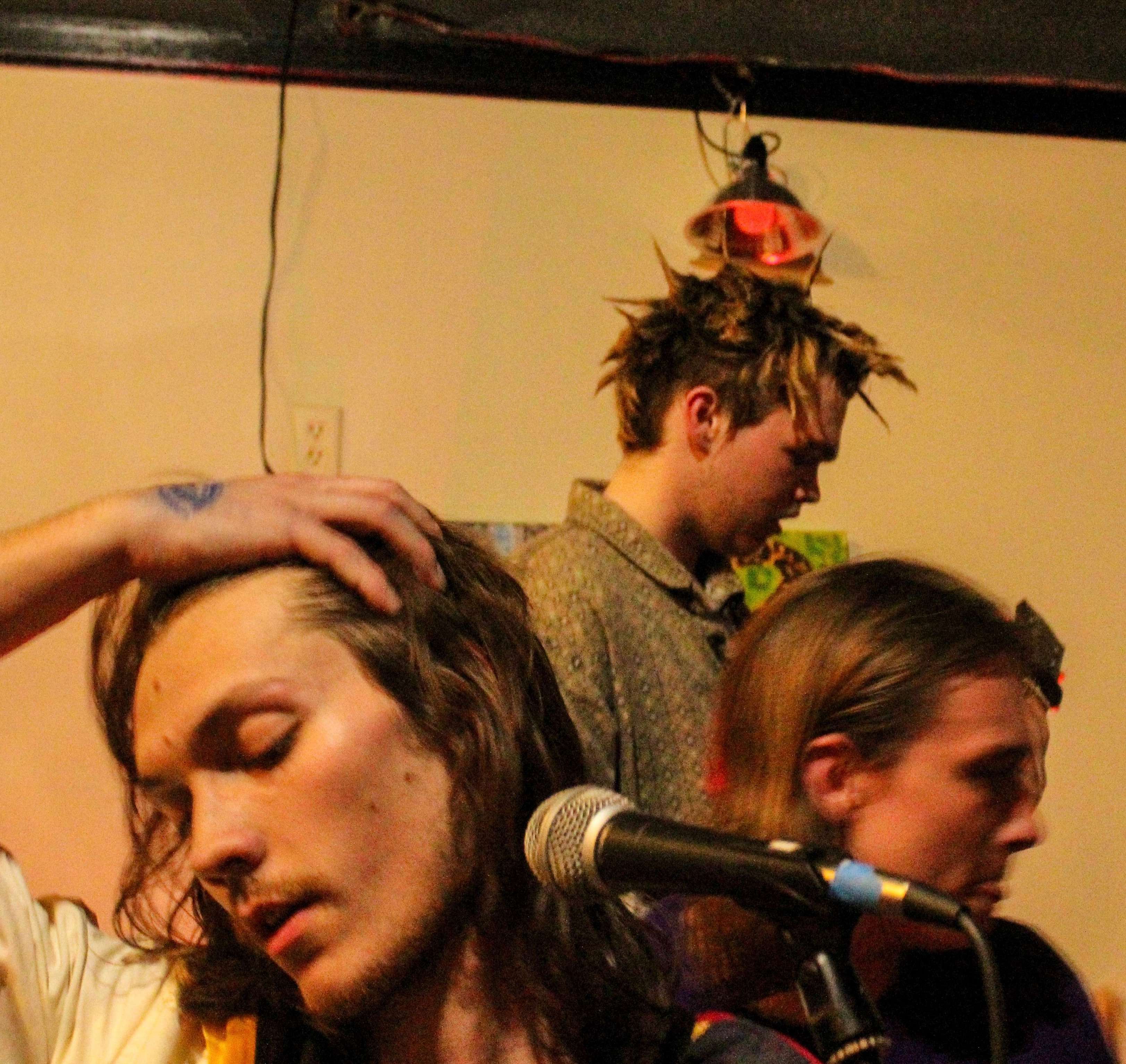 a man with dreadlocks is holding a microphone