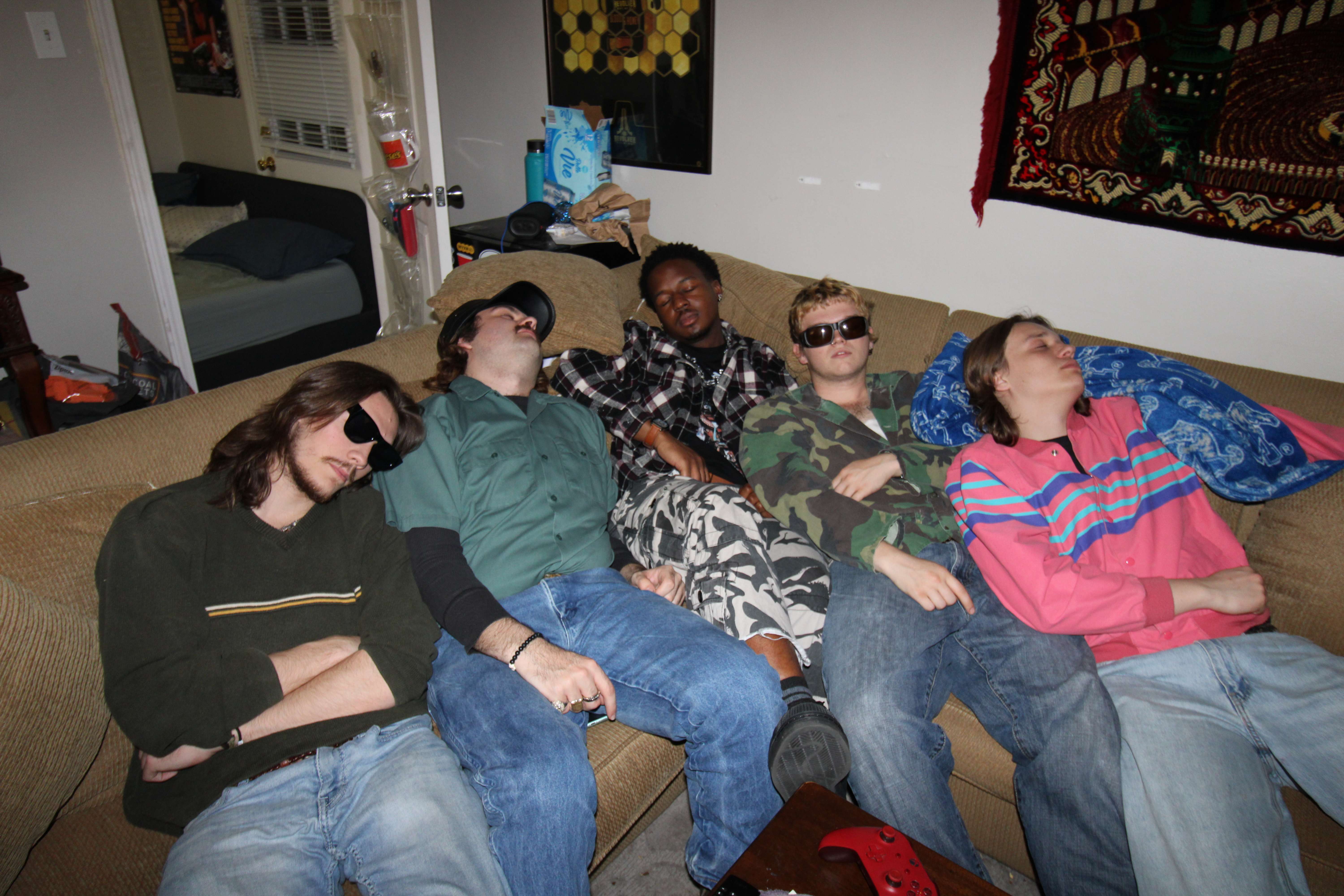a group of people sleeping on a couch