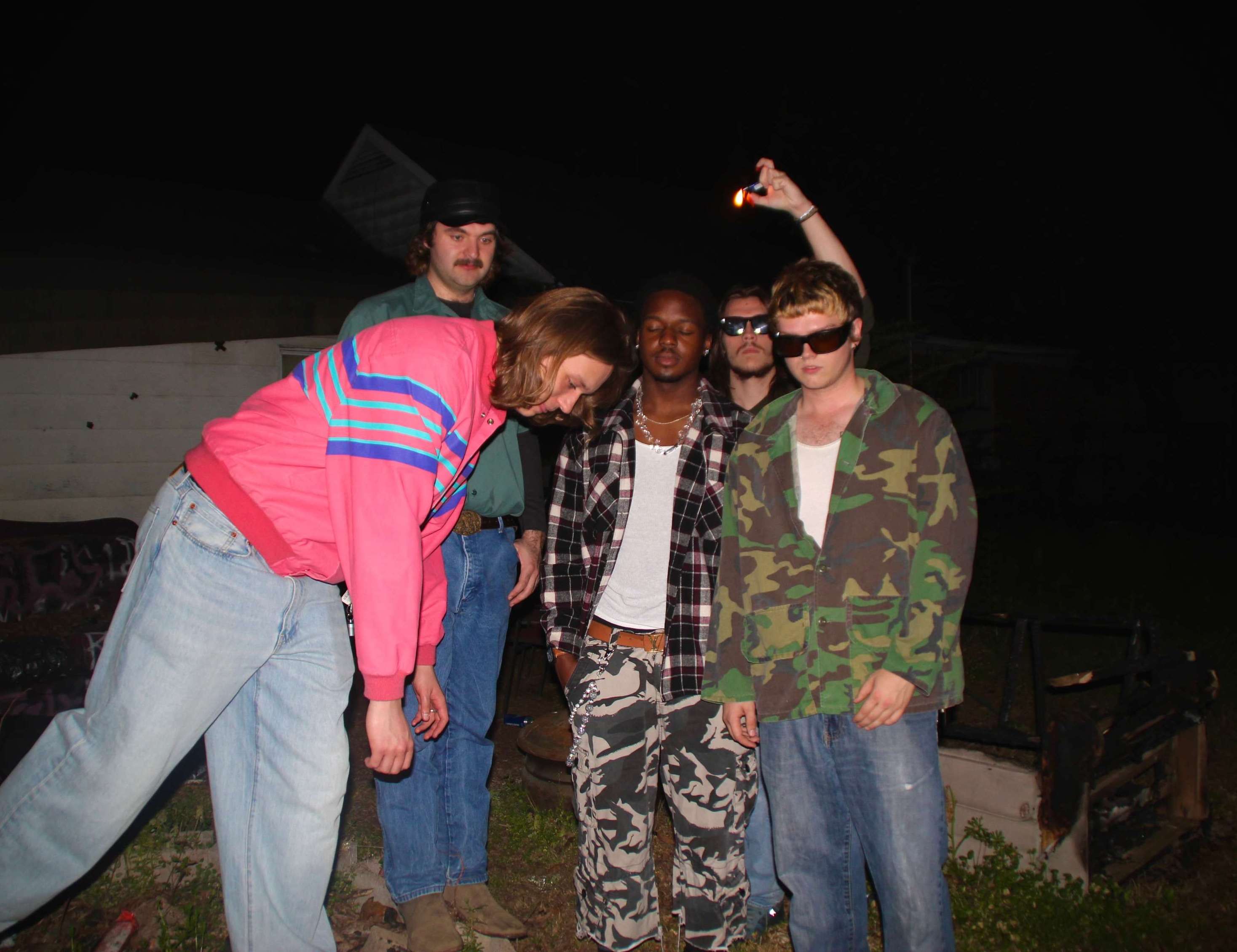 a group of people standing in front of a house