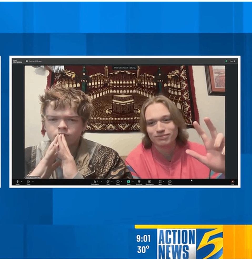 two young men in a video chat on a television screen