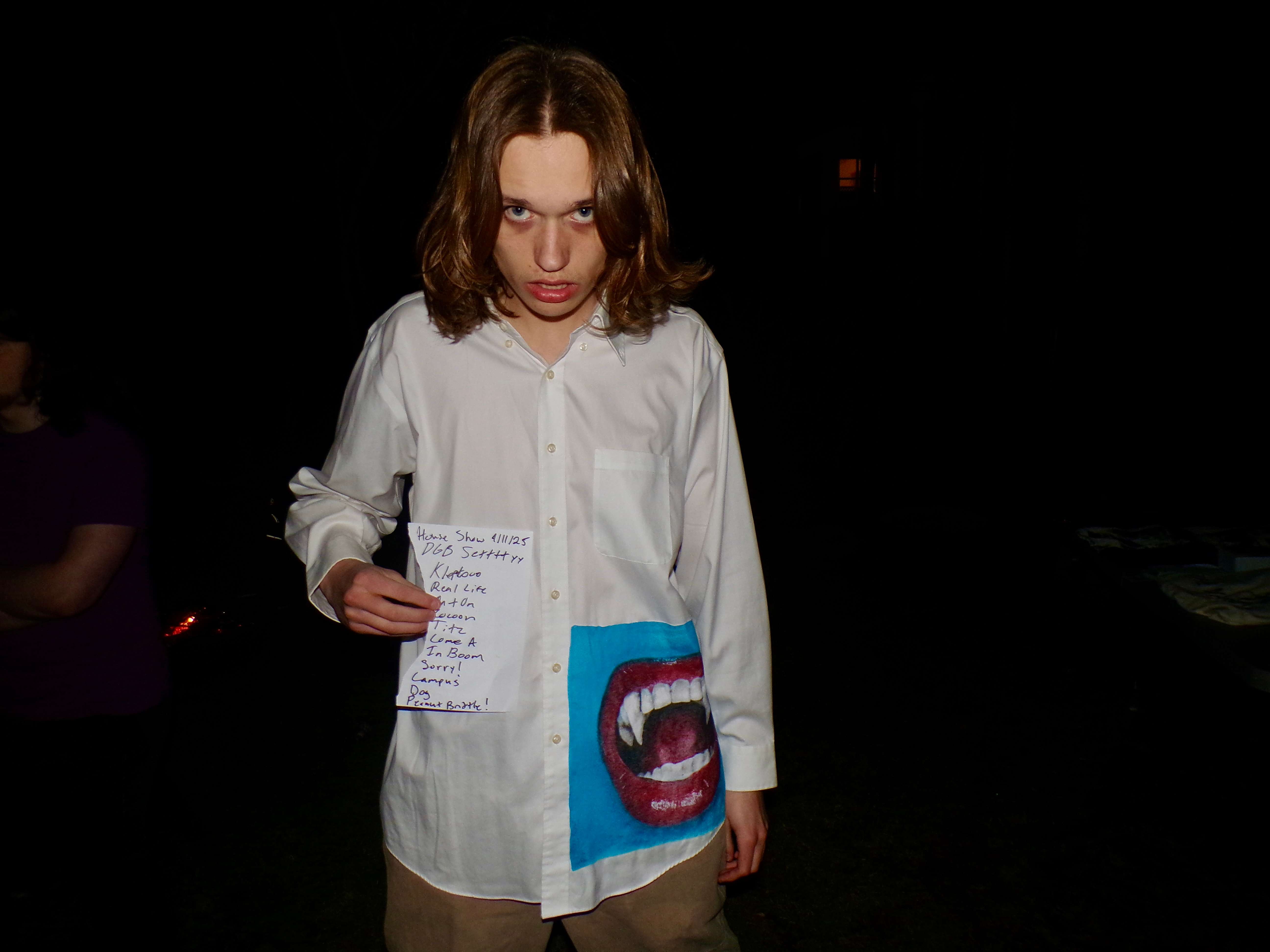 a young man holding a piece of paper