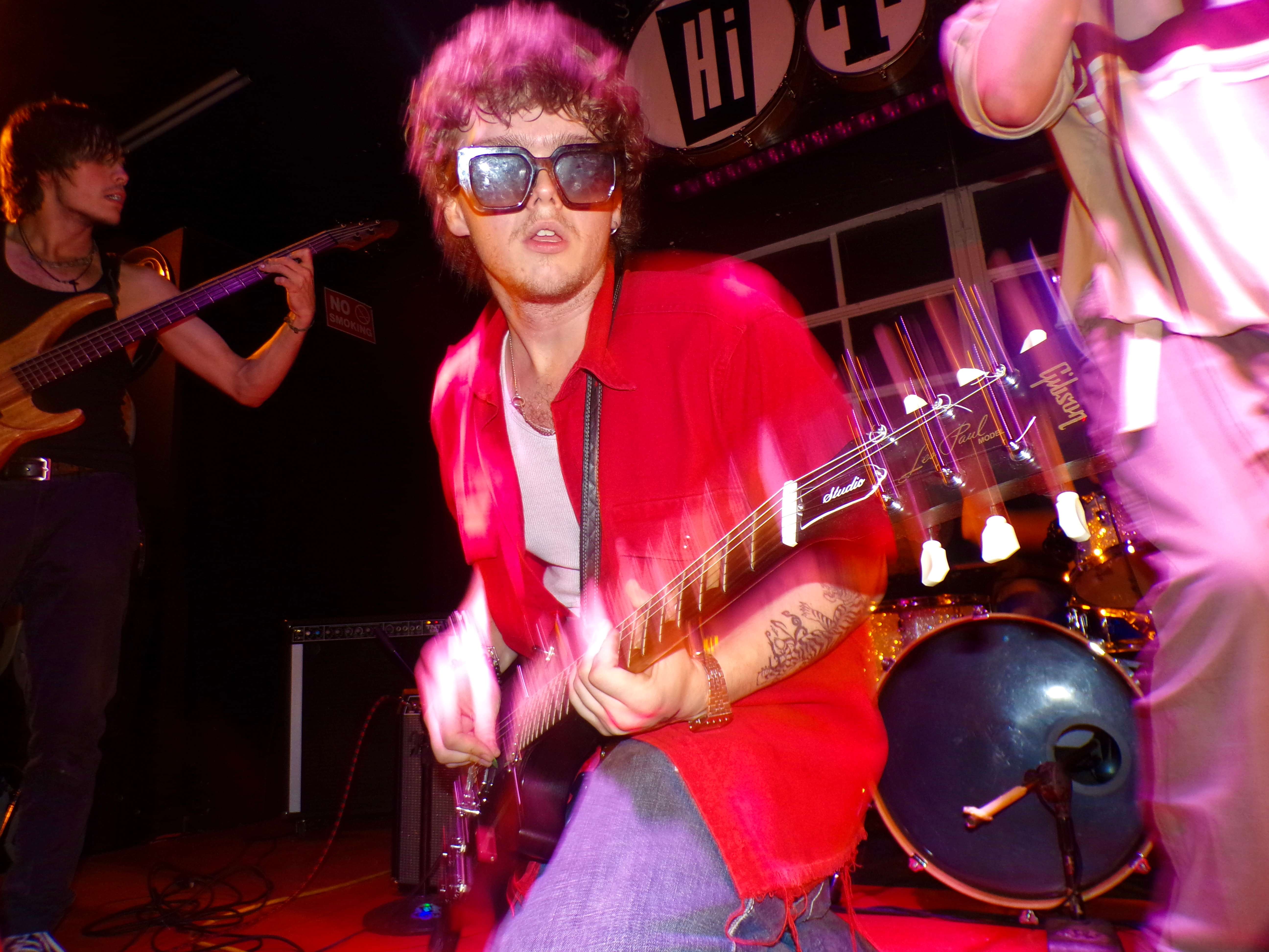a man playing a guitar on stage