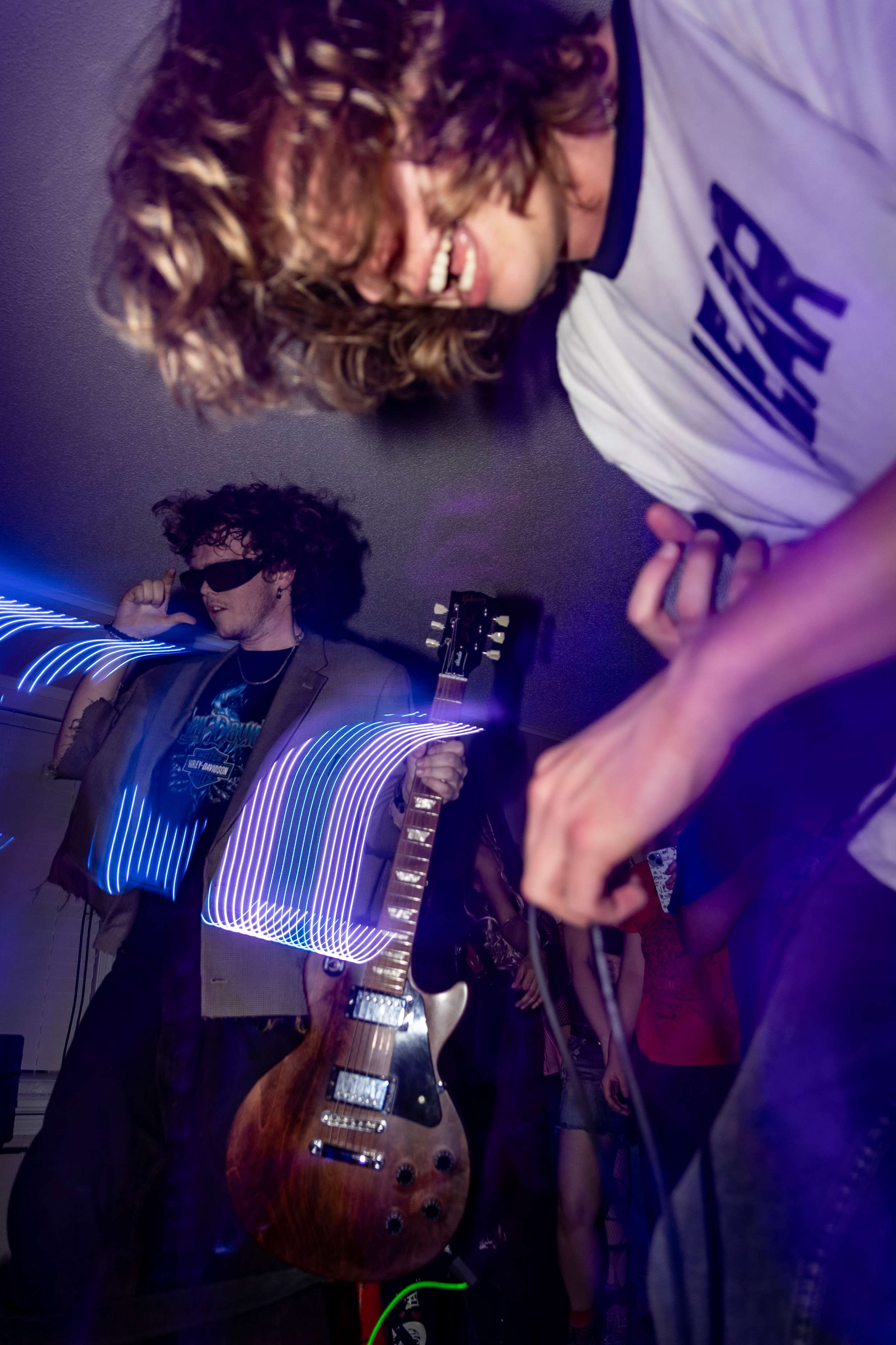 a man is playing a guitar in a dark room