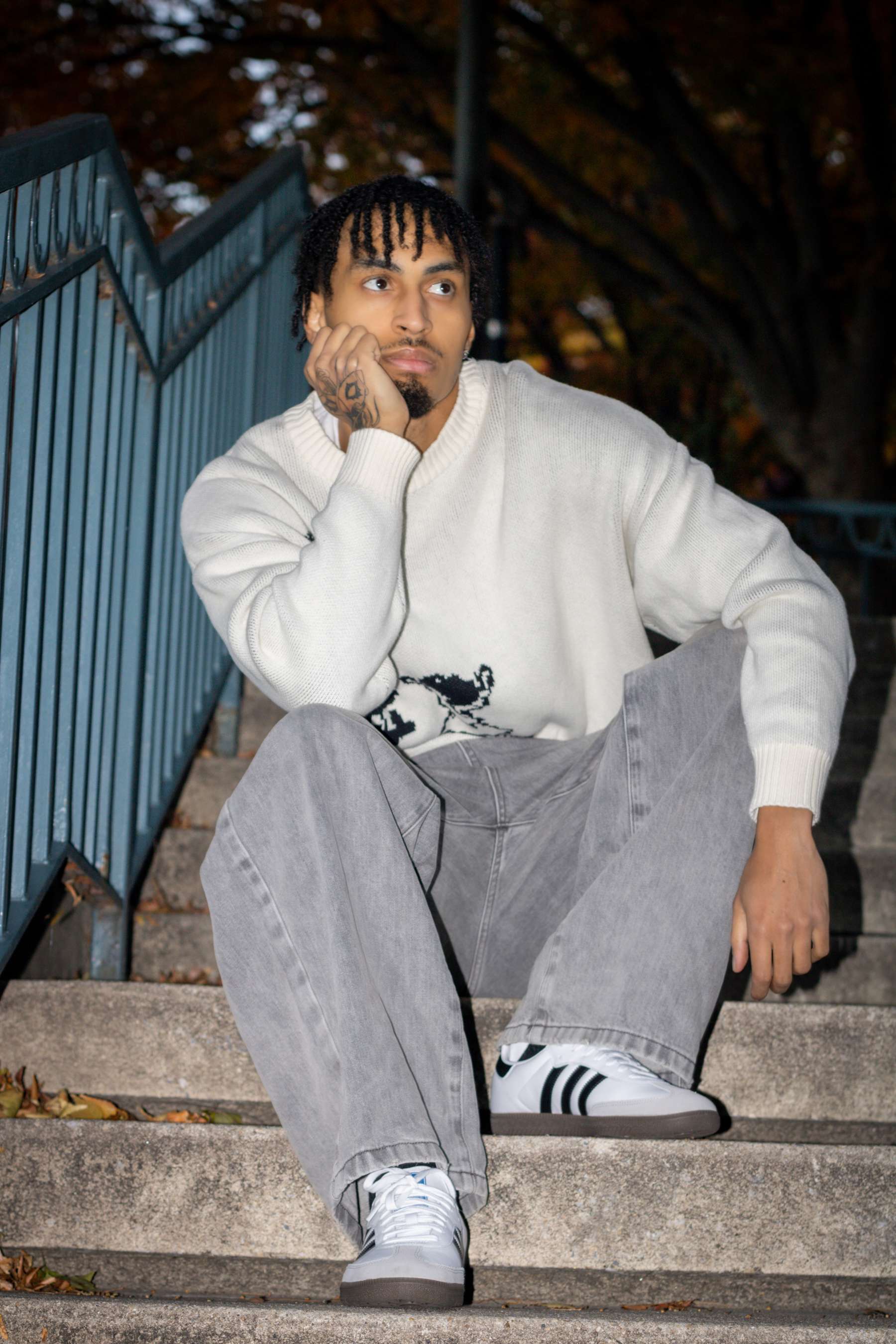 the man is wearing a white sweater