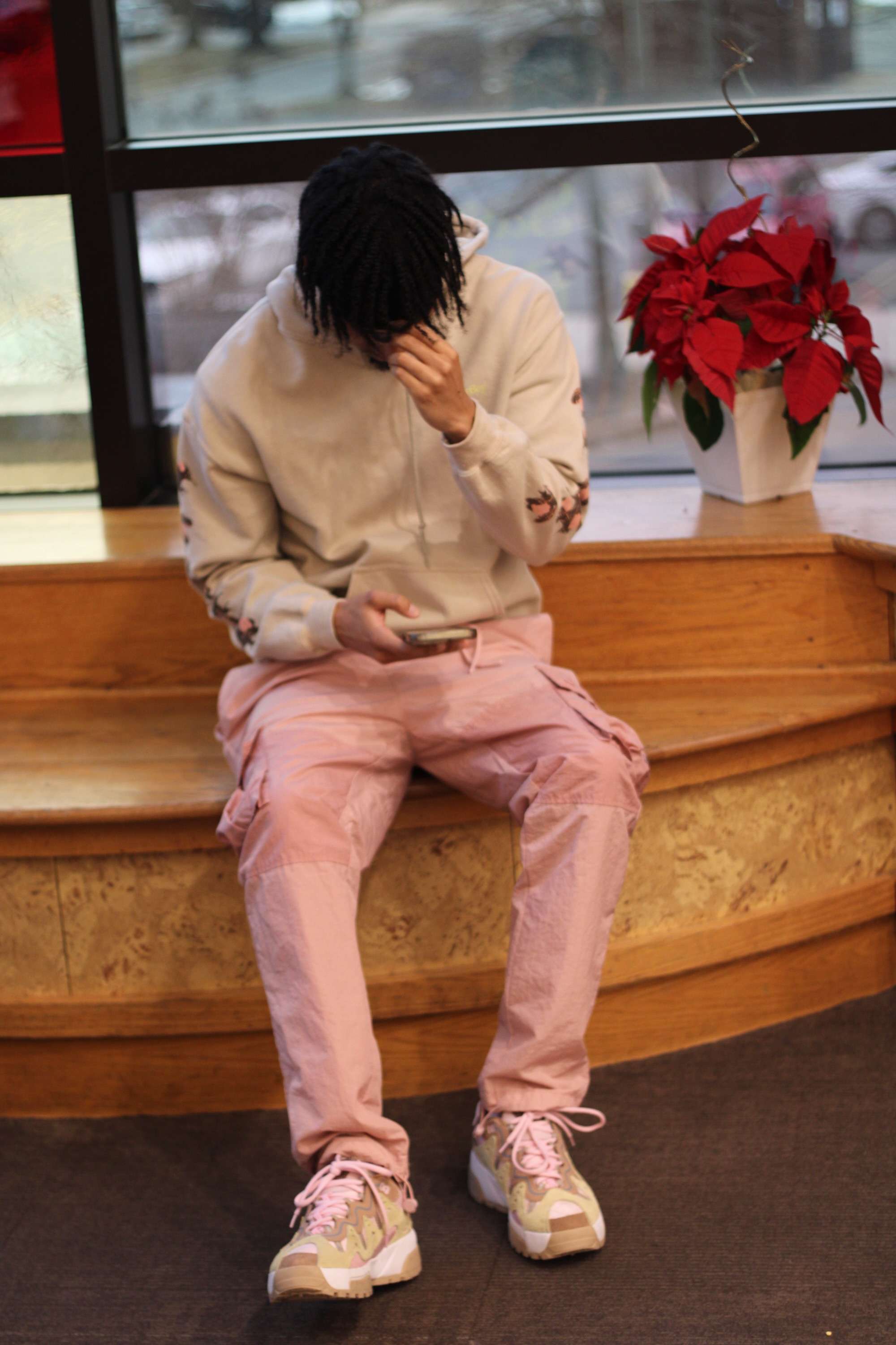 a person sitting on a bench with a cell phone