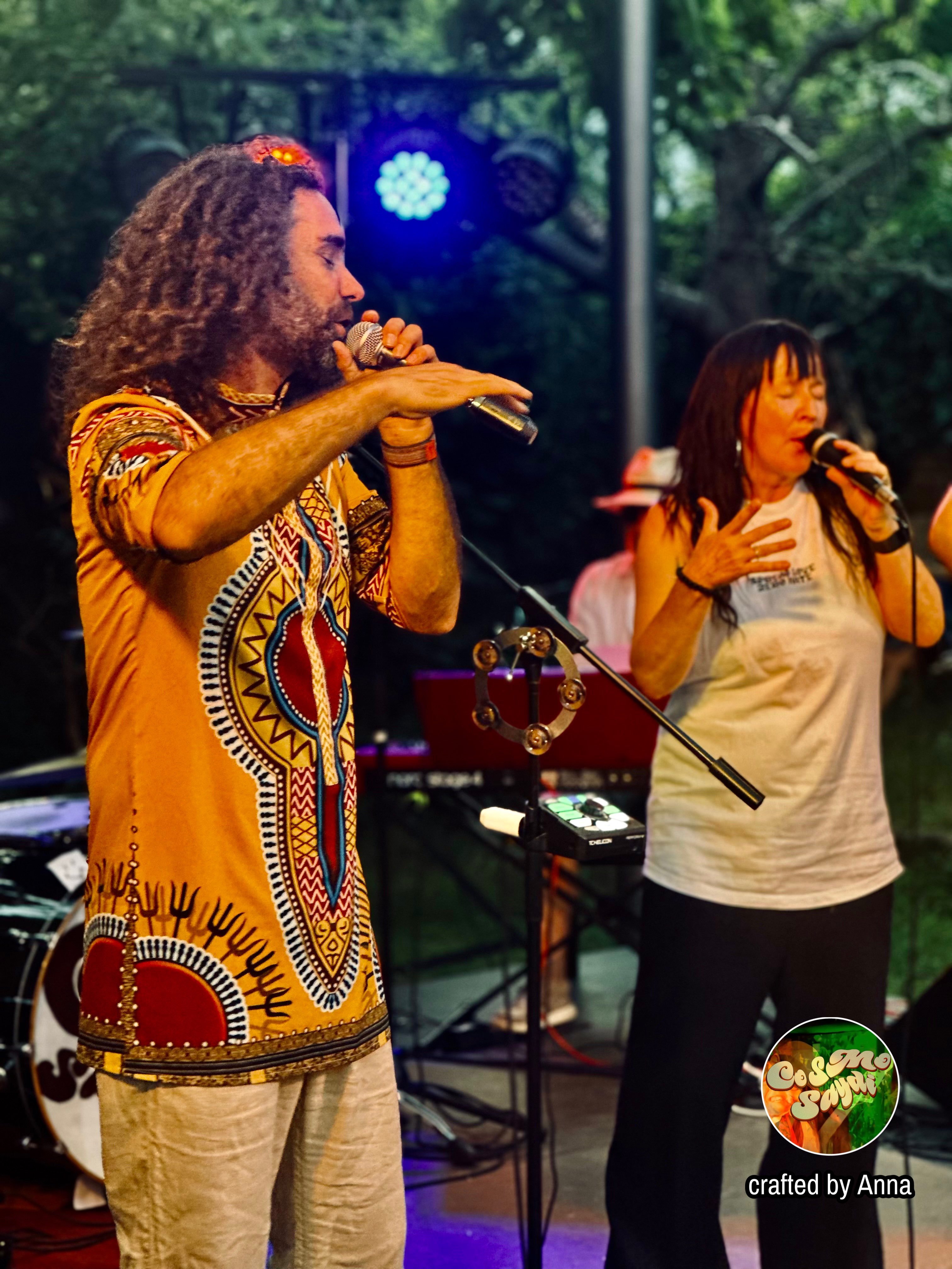 a group of people singing in front of a stage