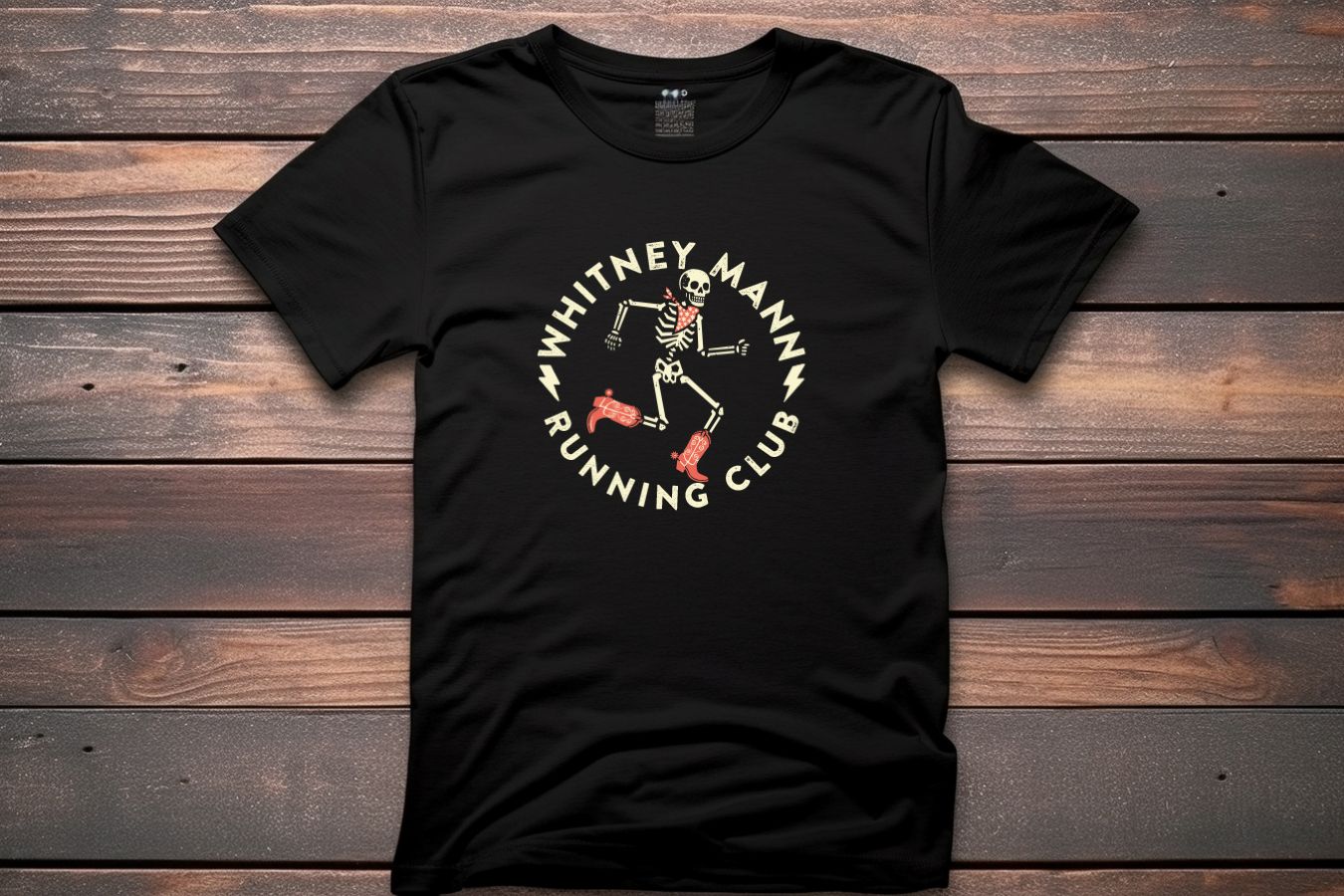 a black t - shirt with an image of a skeleton running