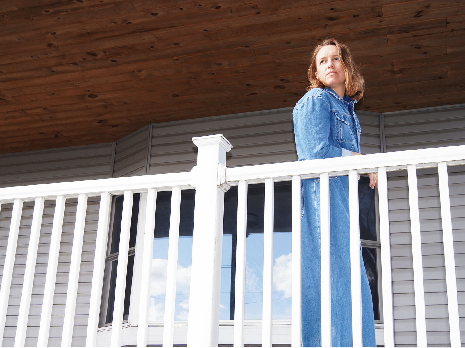 a woman standing on a white railing