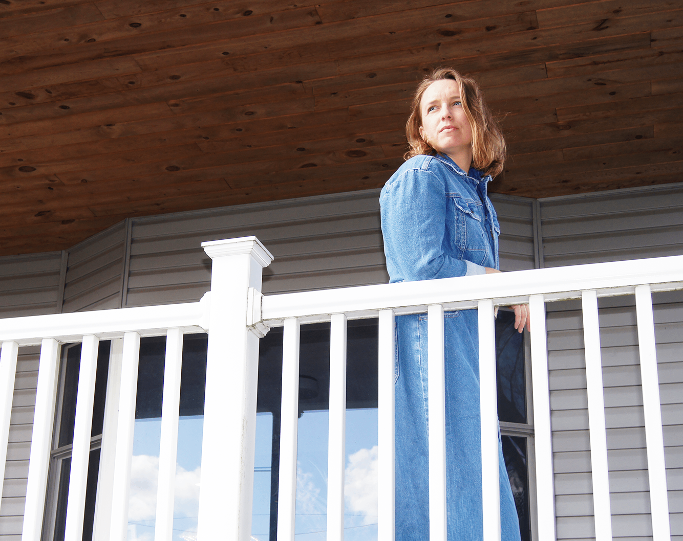 a woman standing on a white railing