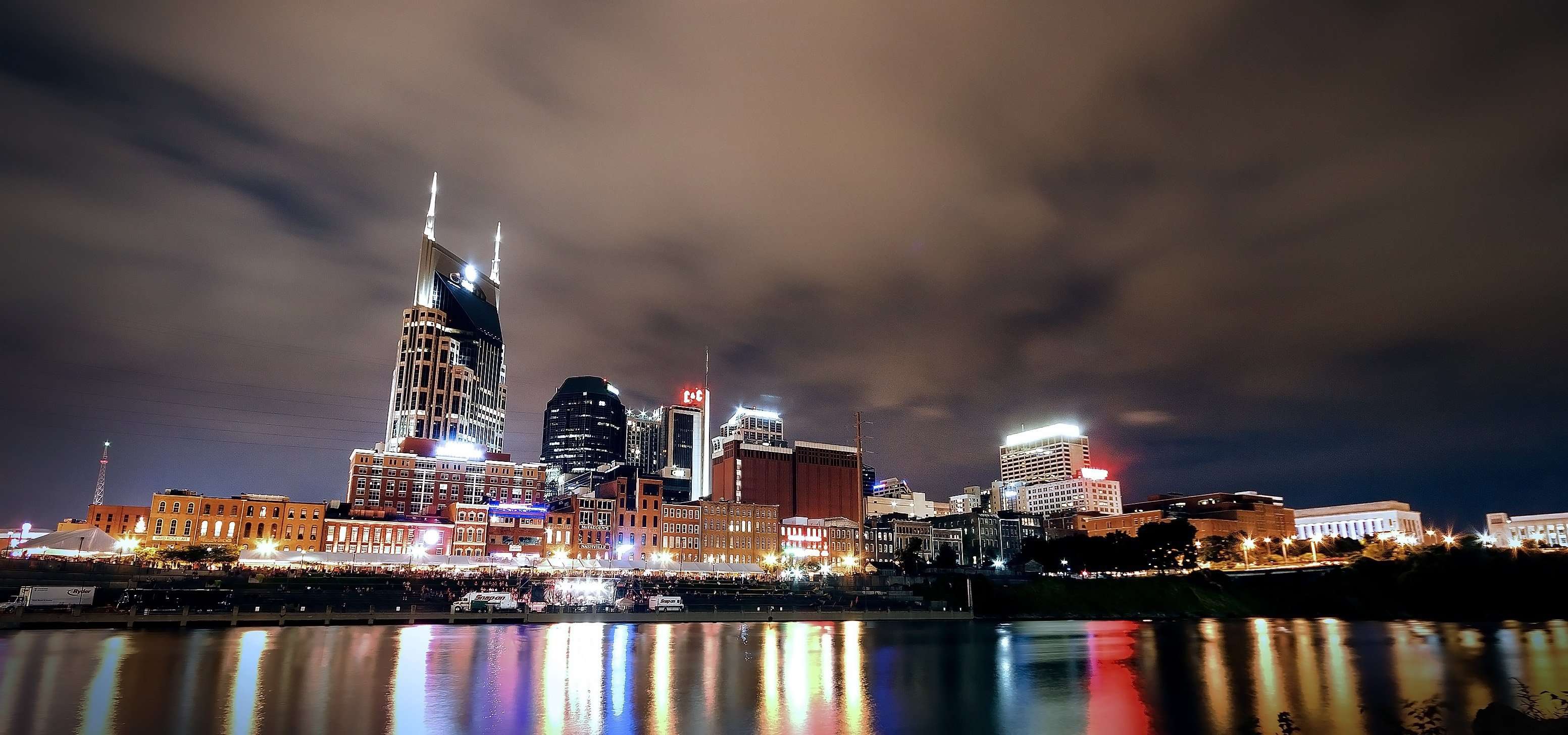 nashville skyline reflected in a body of water at night