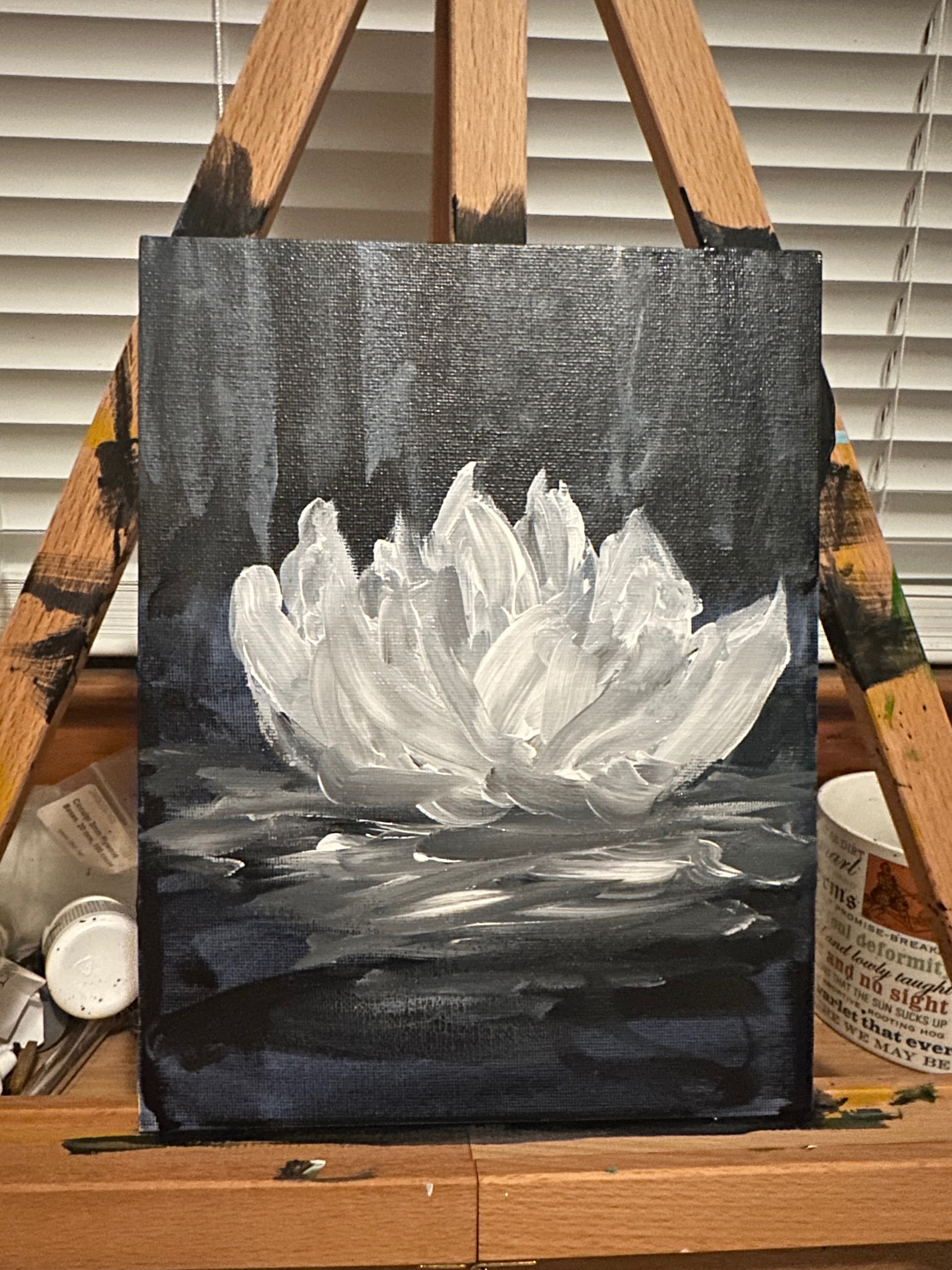 a painting of a white flower on an easel