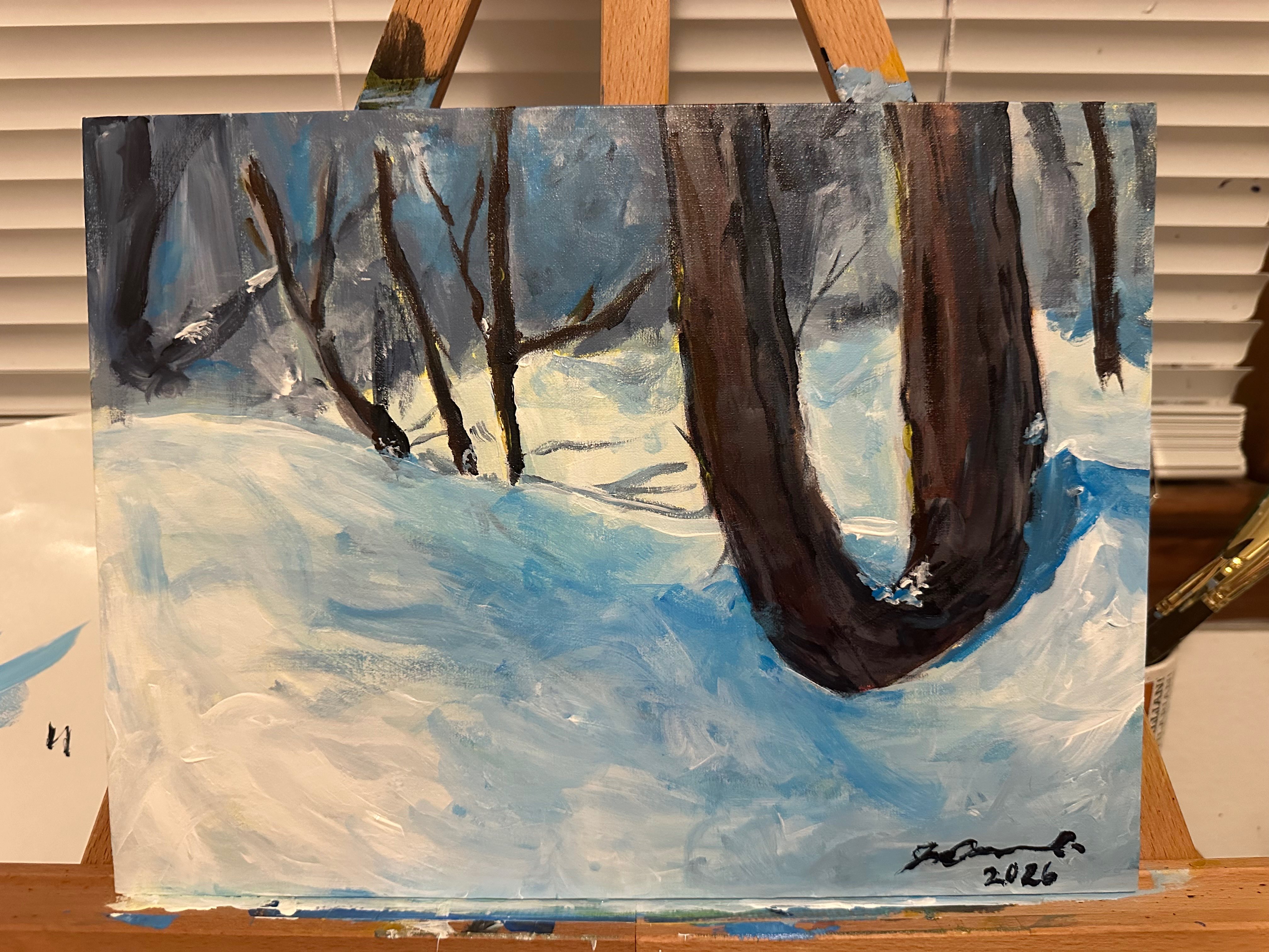 a painting of a snowy scene on an easel