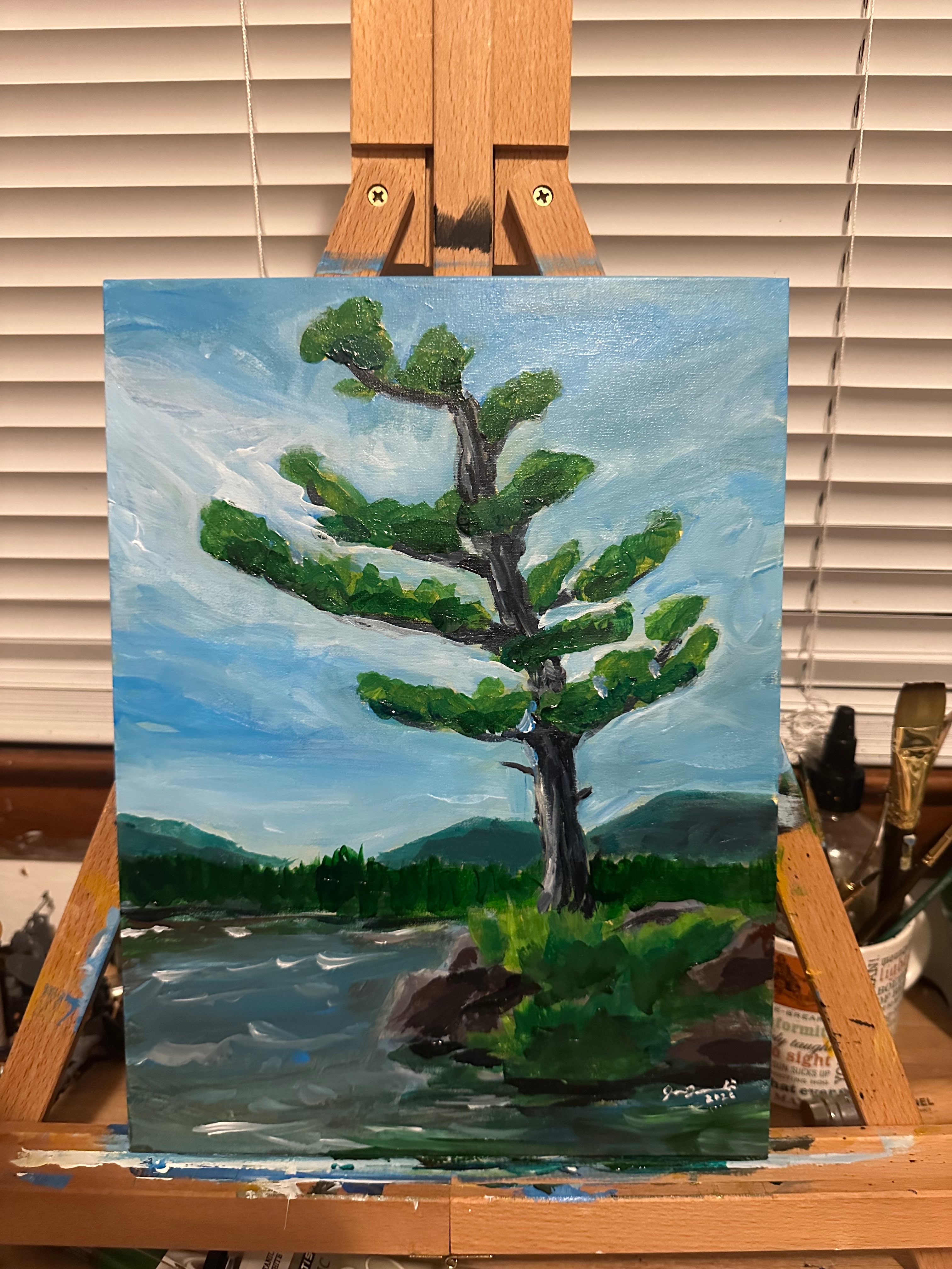 a painting of a pine tree on an easel