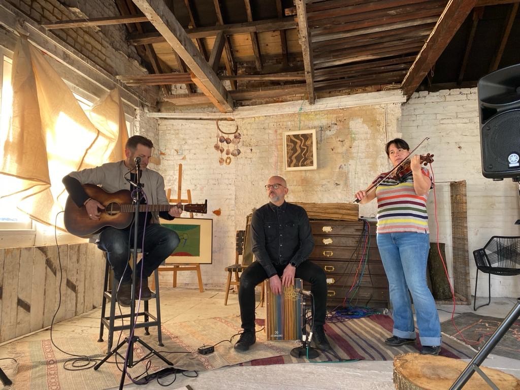 a group of people playing music in an old room