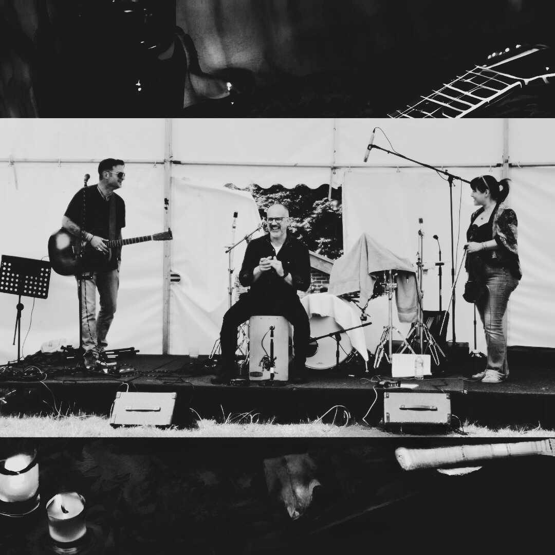 a black and white photo of a band on stage
