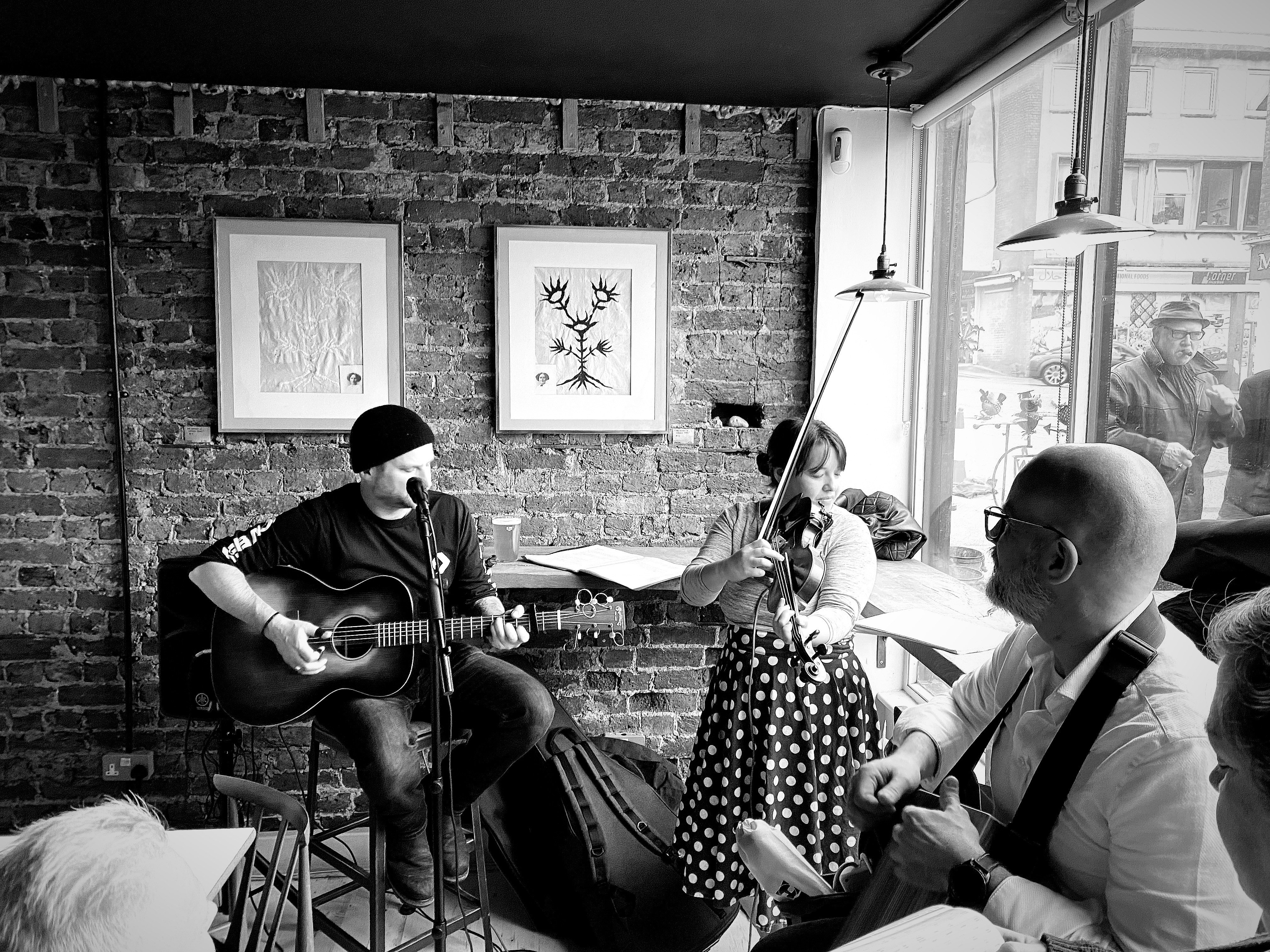 a black and white photo of a group of people playing music