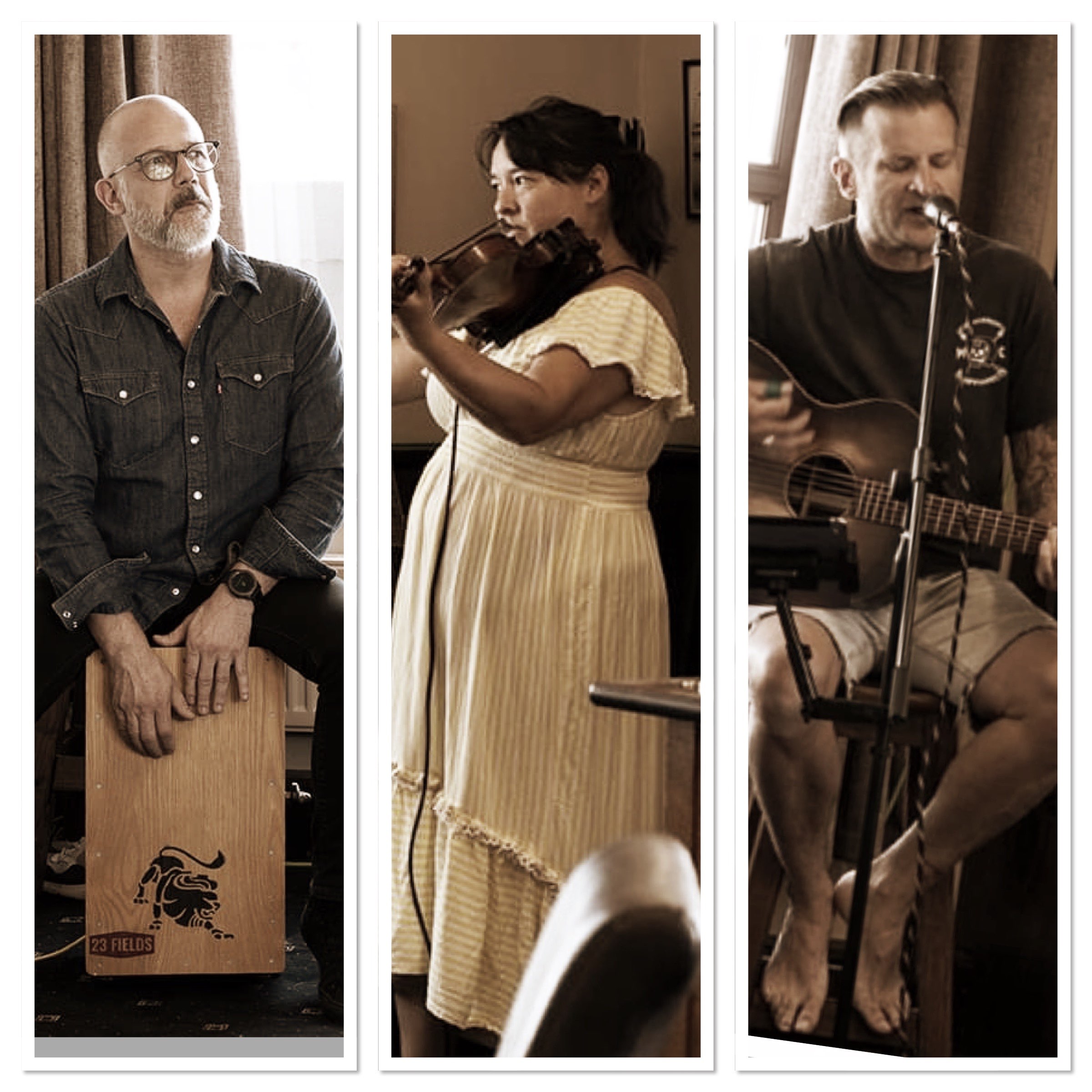 four people are sitting in a room playing music