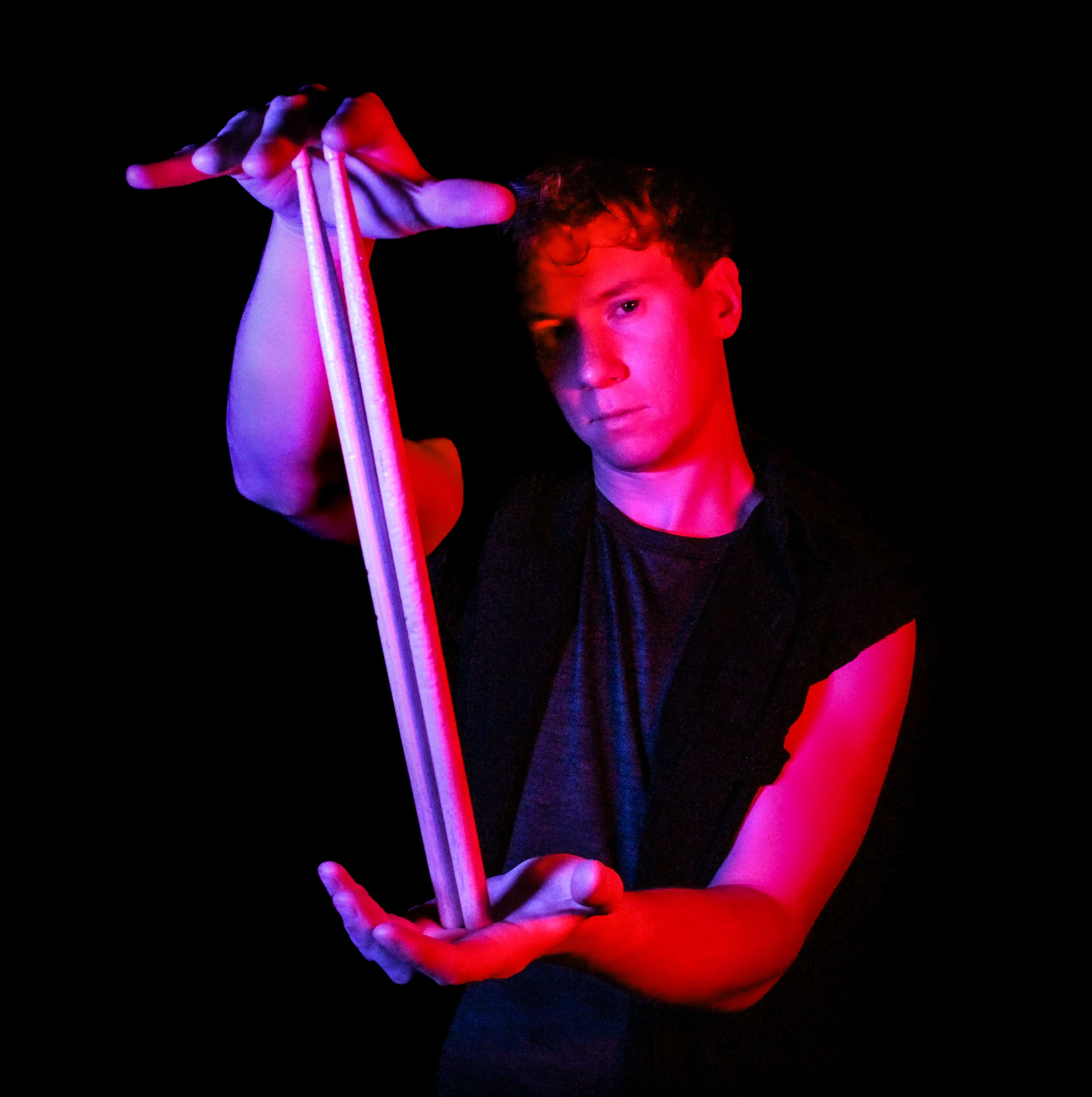 a man holding two sticks in his hands