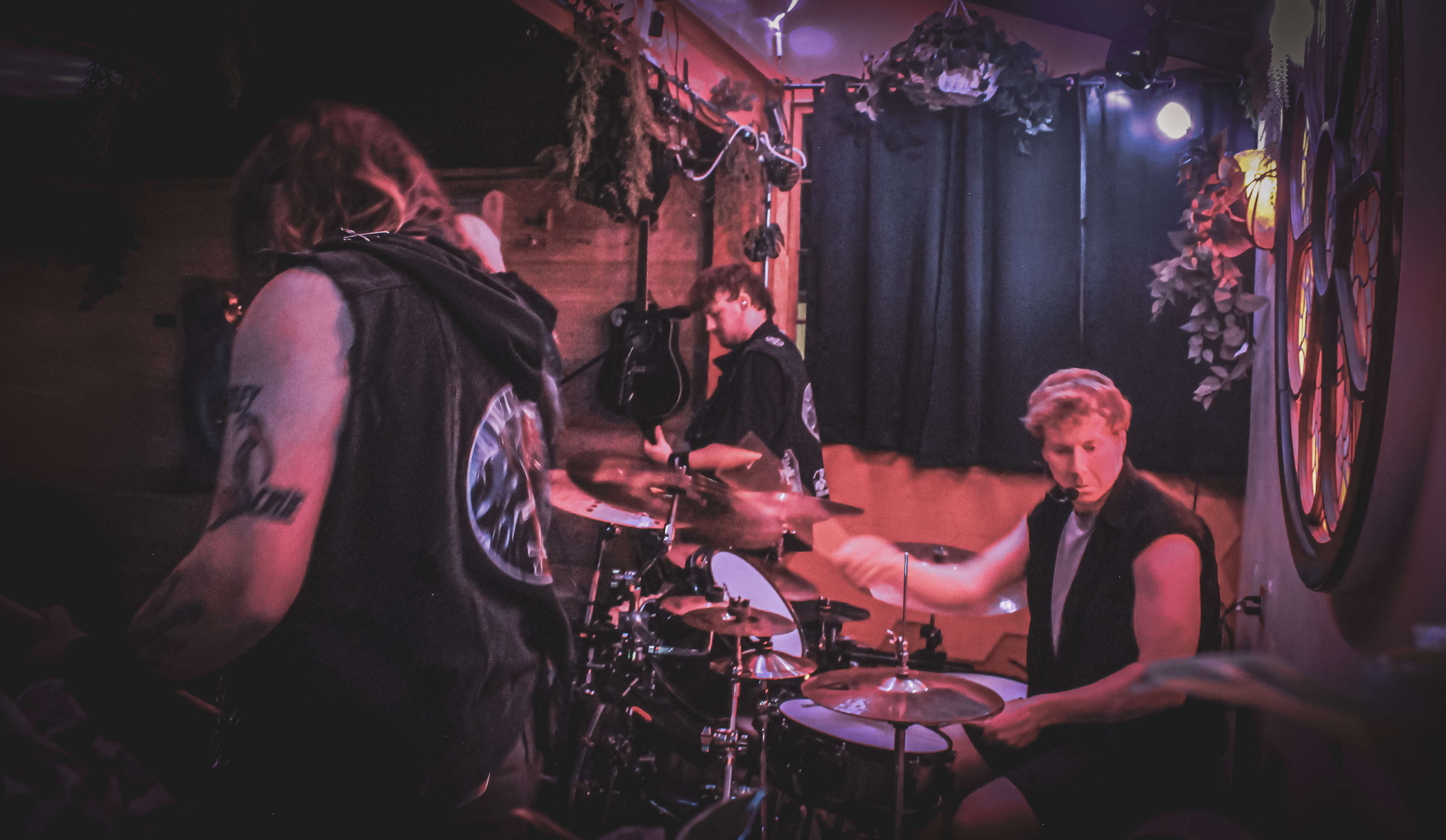 a group of people playing drums in a dark room