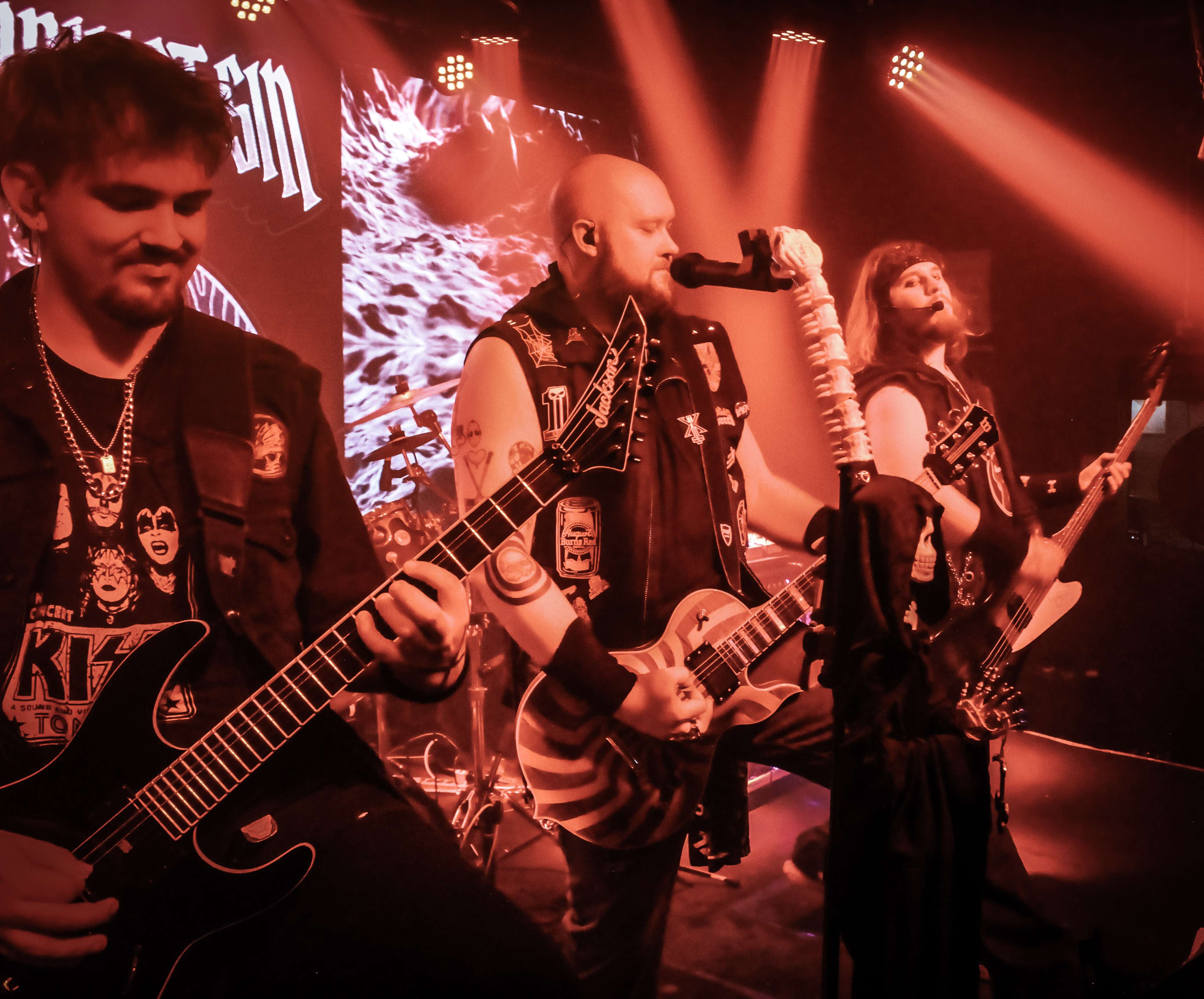a group of men playing guitars on stage
