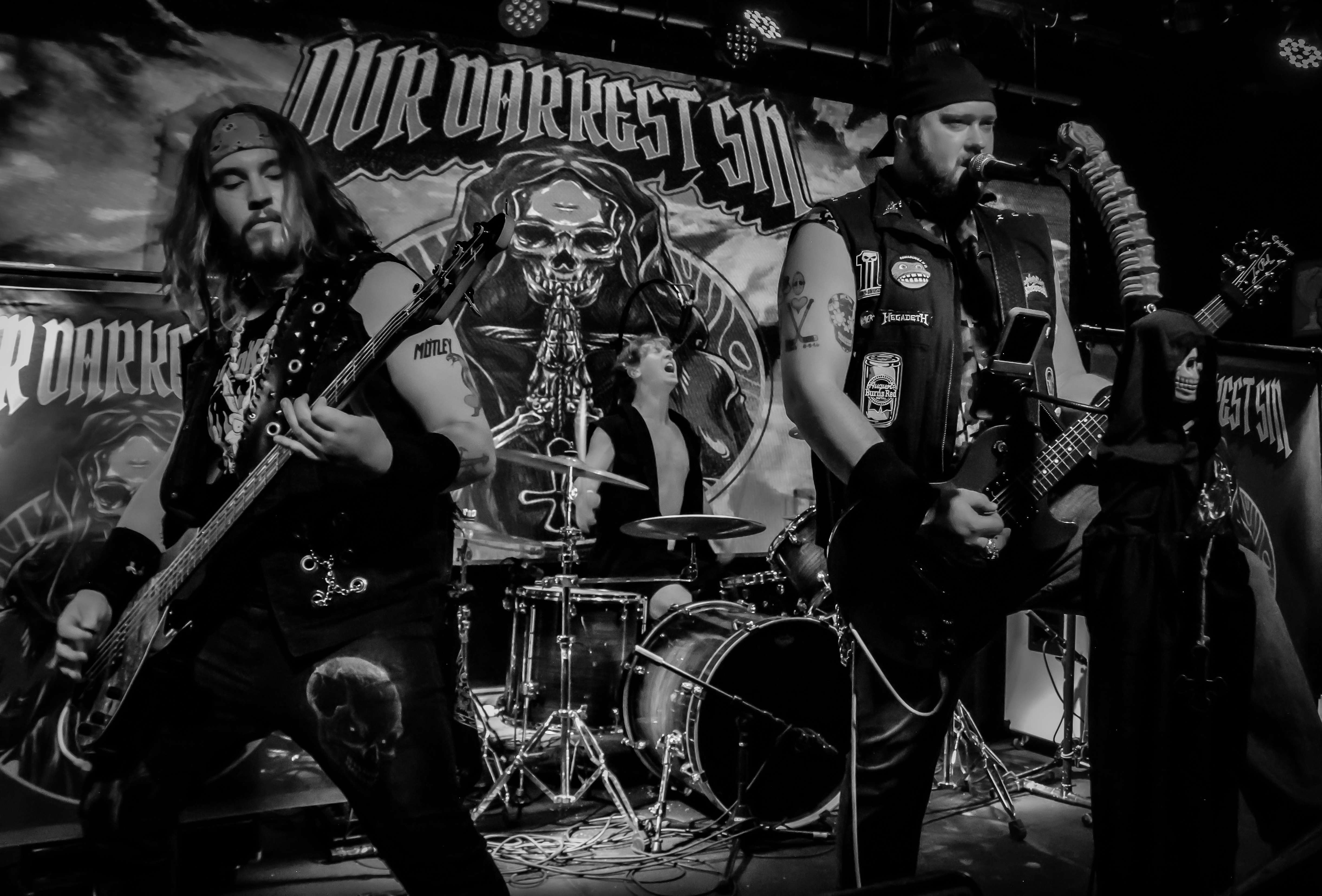 a black and white photo of a band playing a guitar