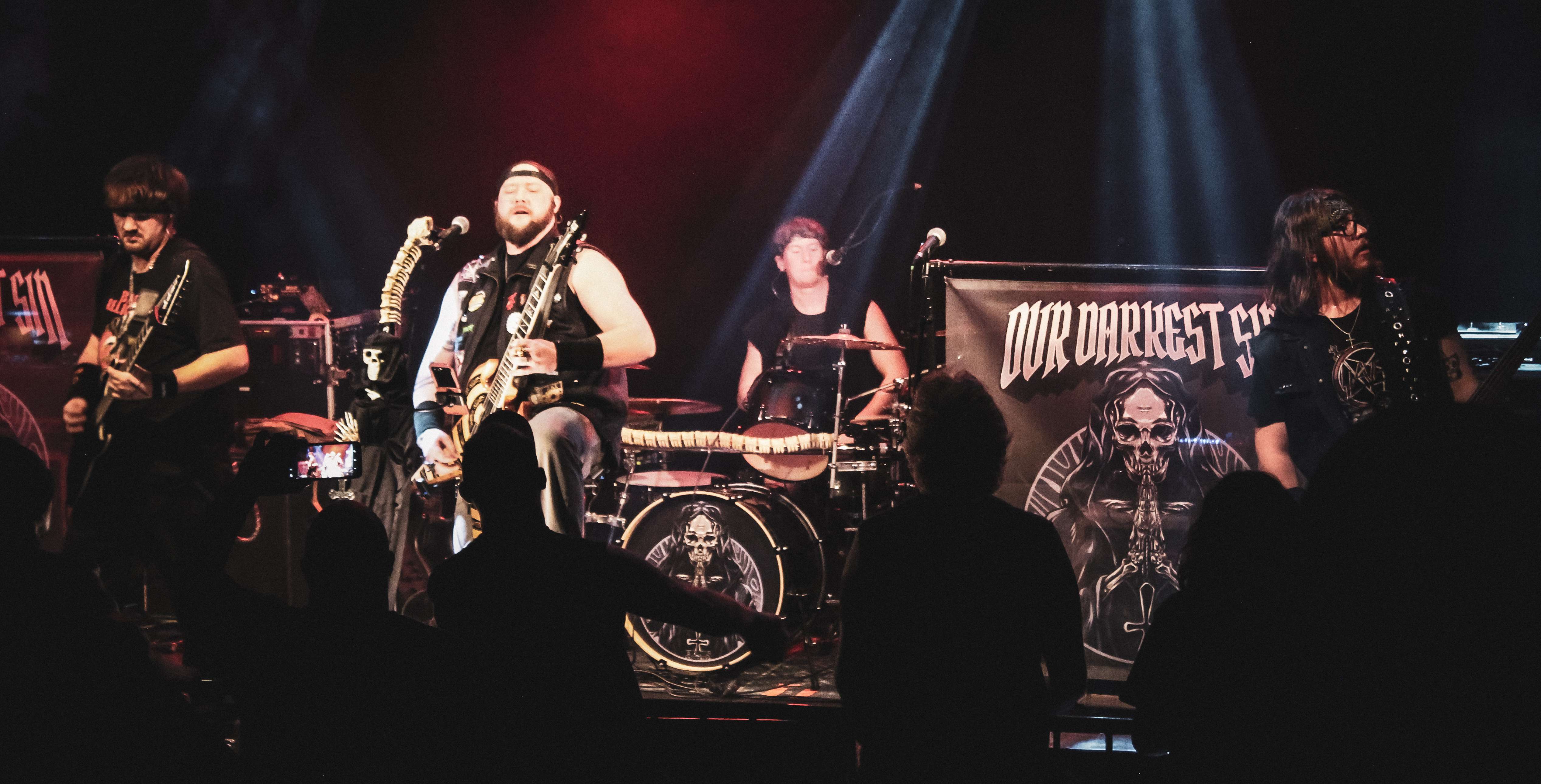 the band is performing on stage in front of a crowd