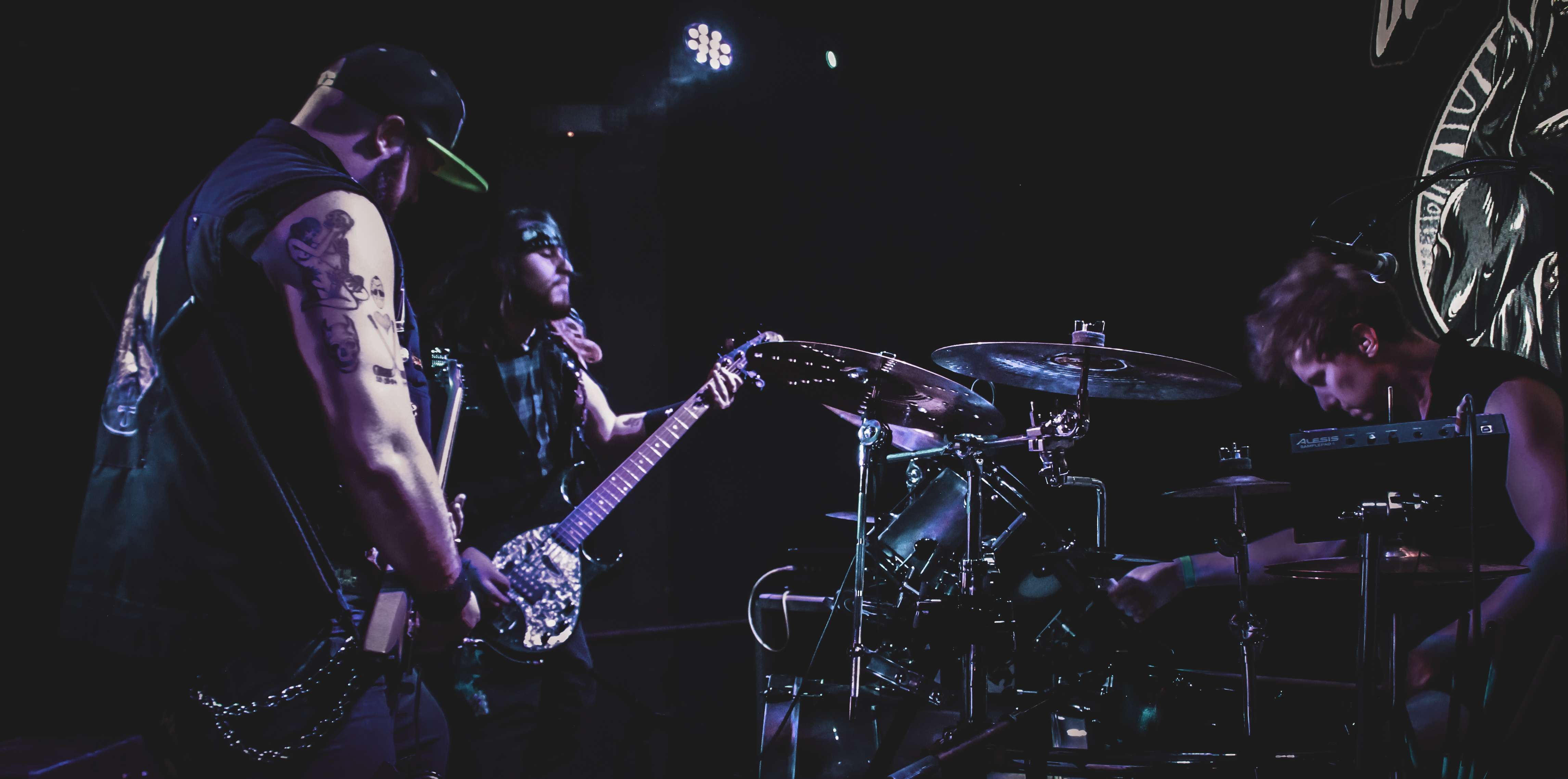 a group of people playing drums in a dark room
