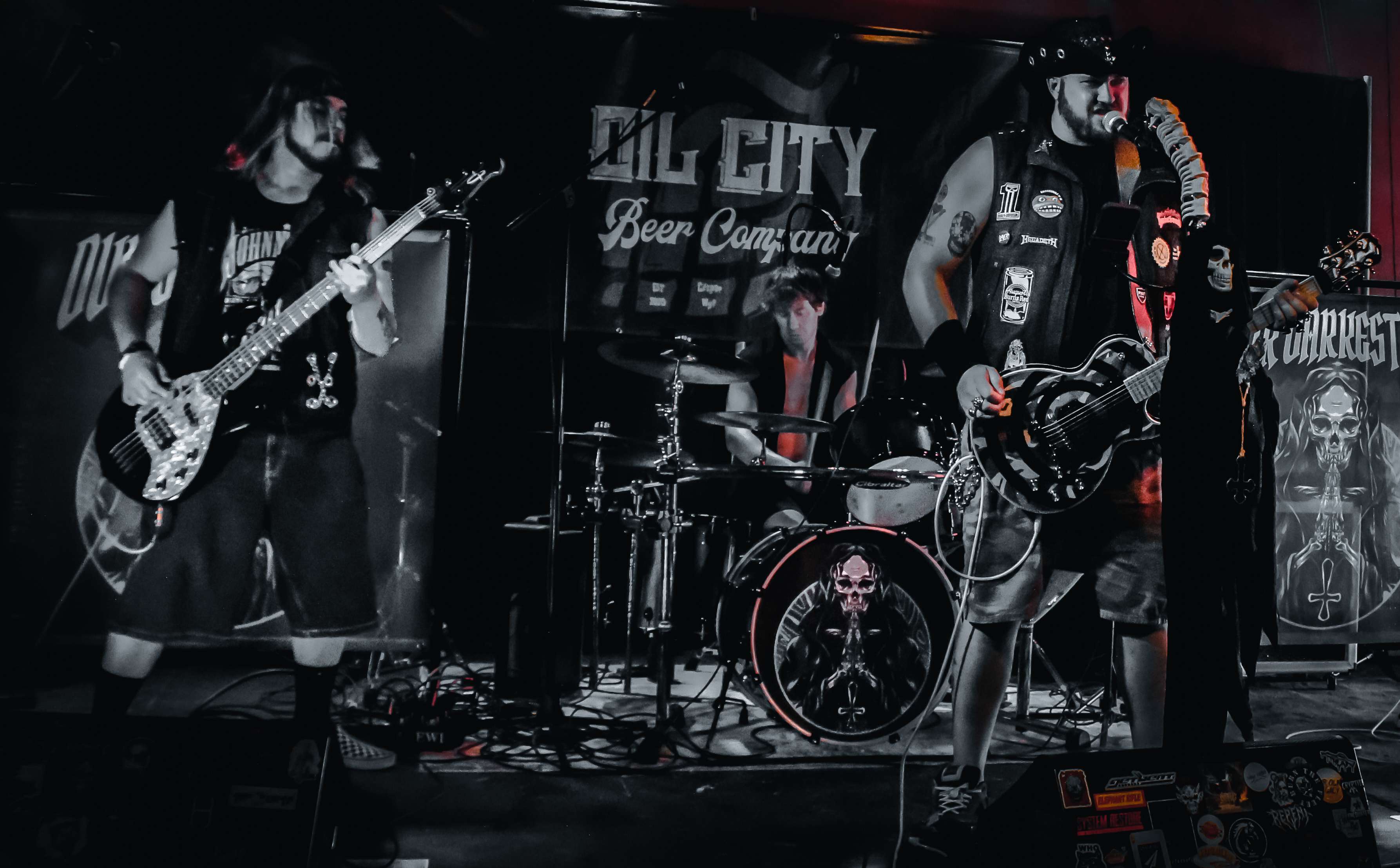 a group of musicians playing music in a dark room