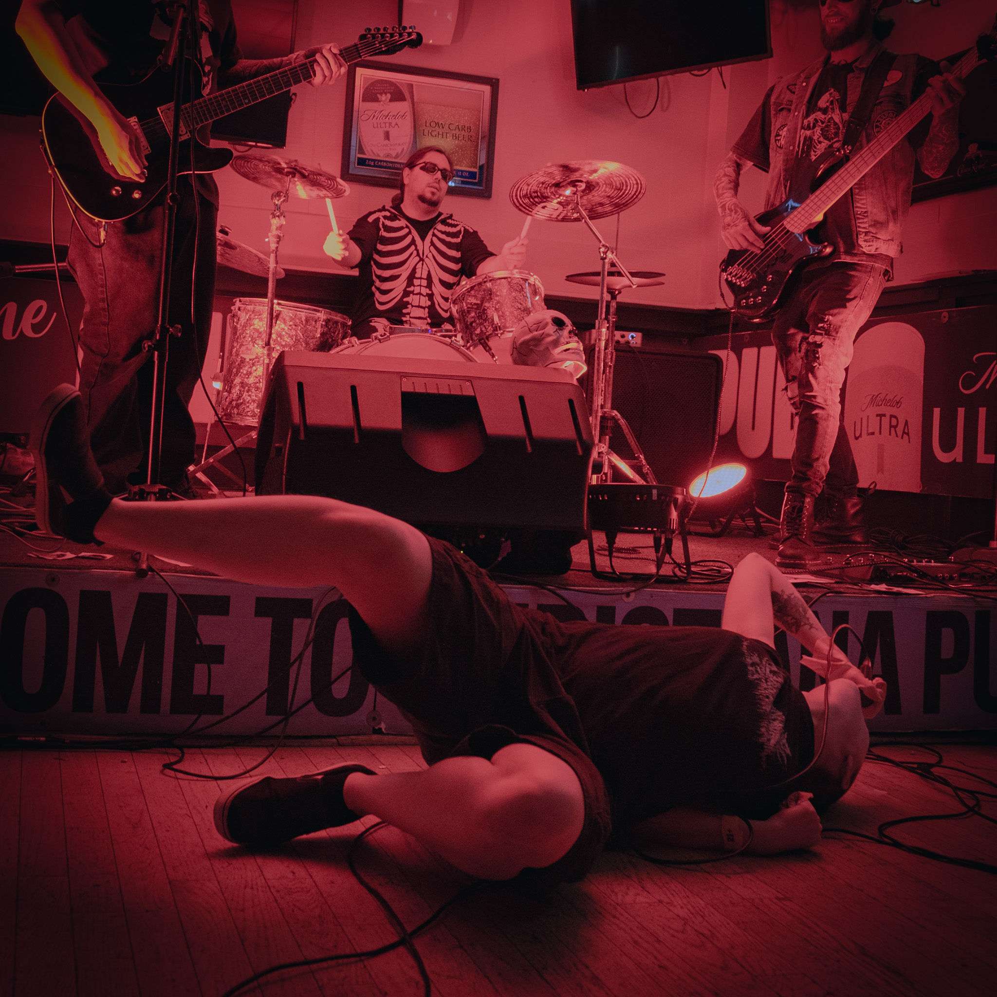 a man laying on the floor in front of a band
