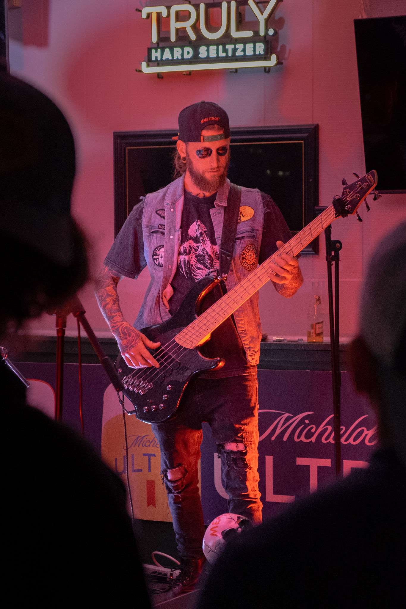 a man playing a bass in a bar