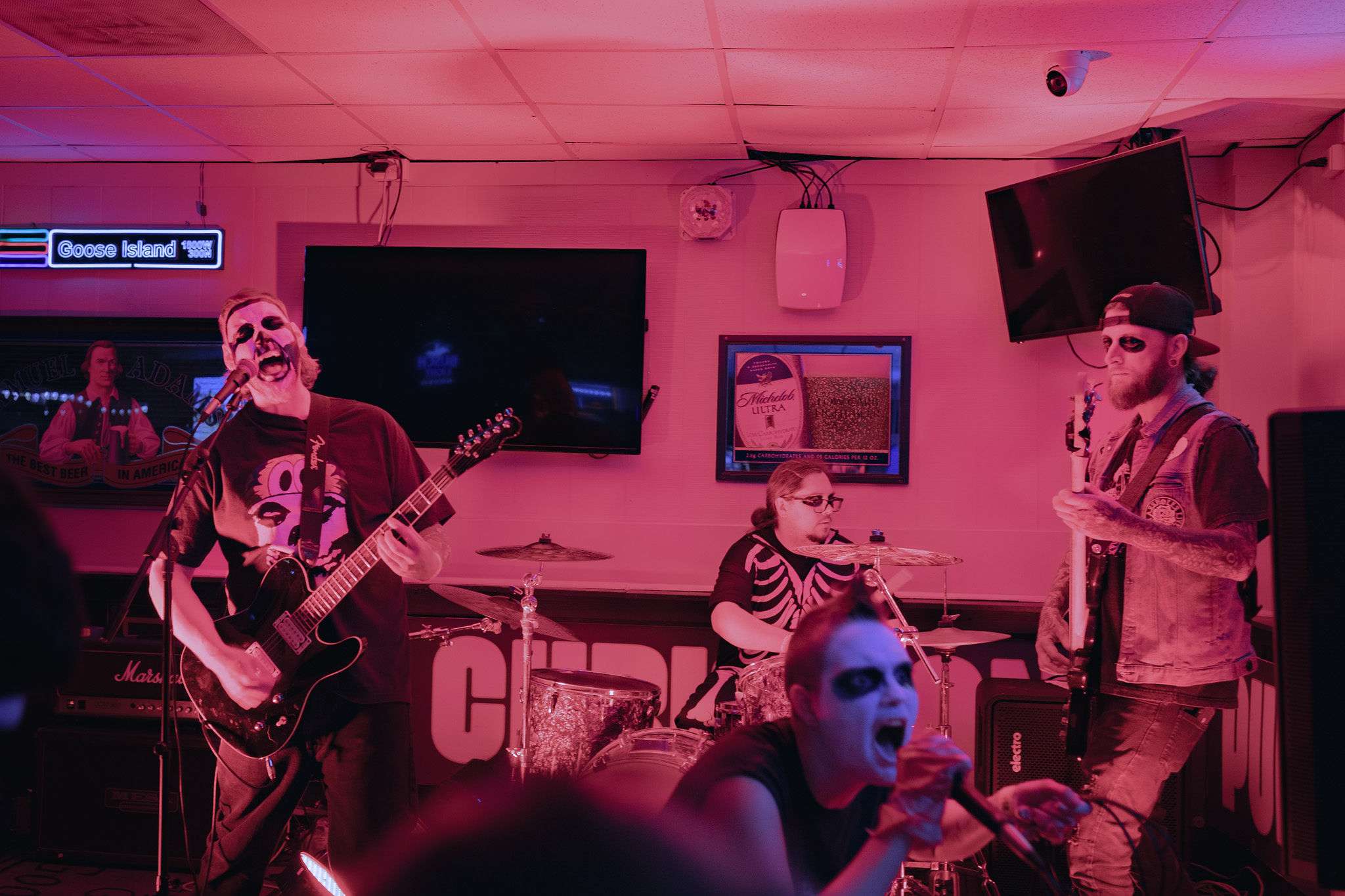 a group of people playing music in a bar