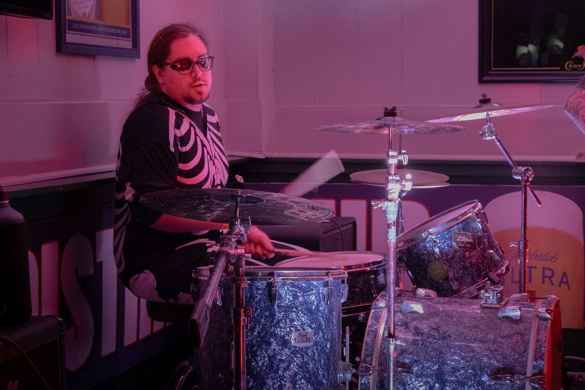 a man playing drums in a bar