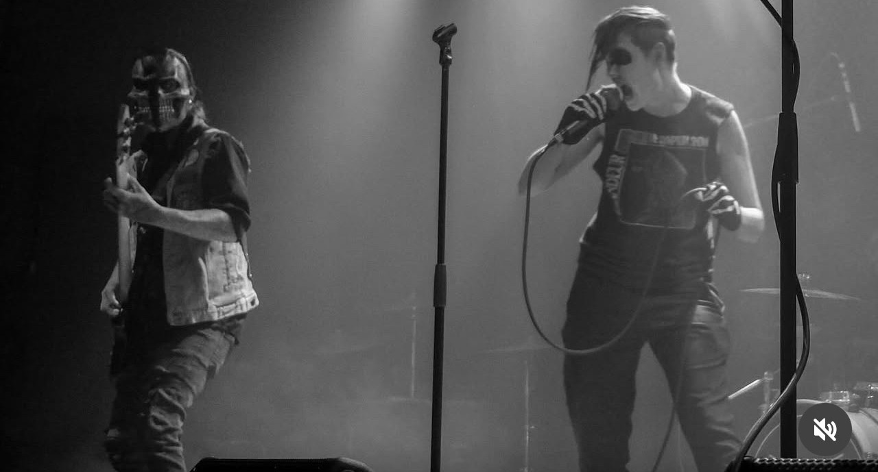 black and white photo of two men on stage