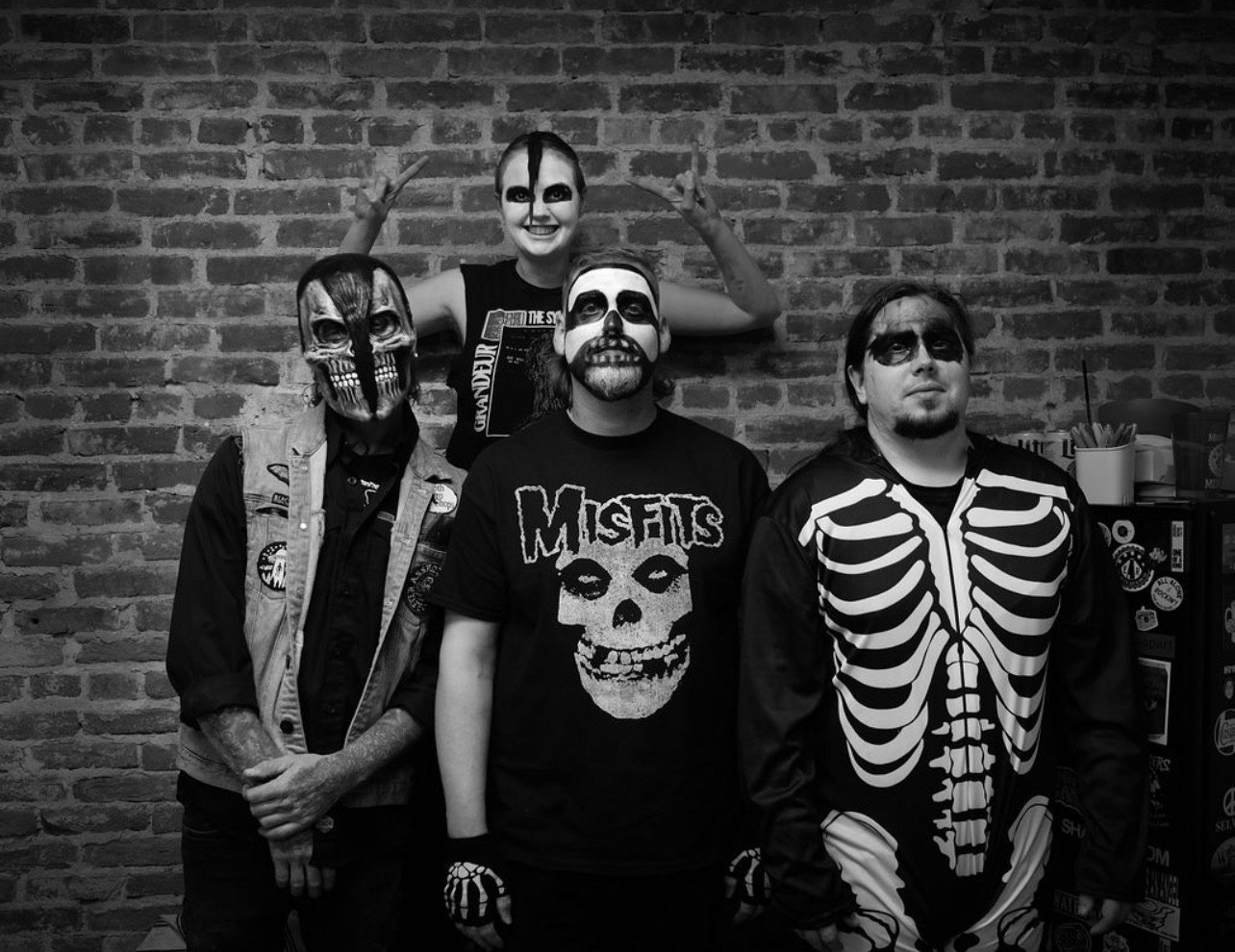 a black and white photo of a group of people dressed in skeleton costumes