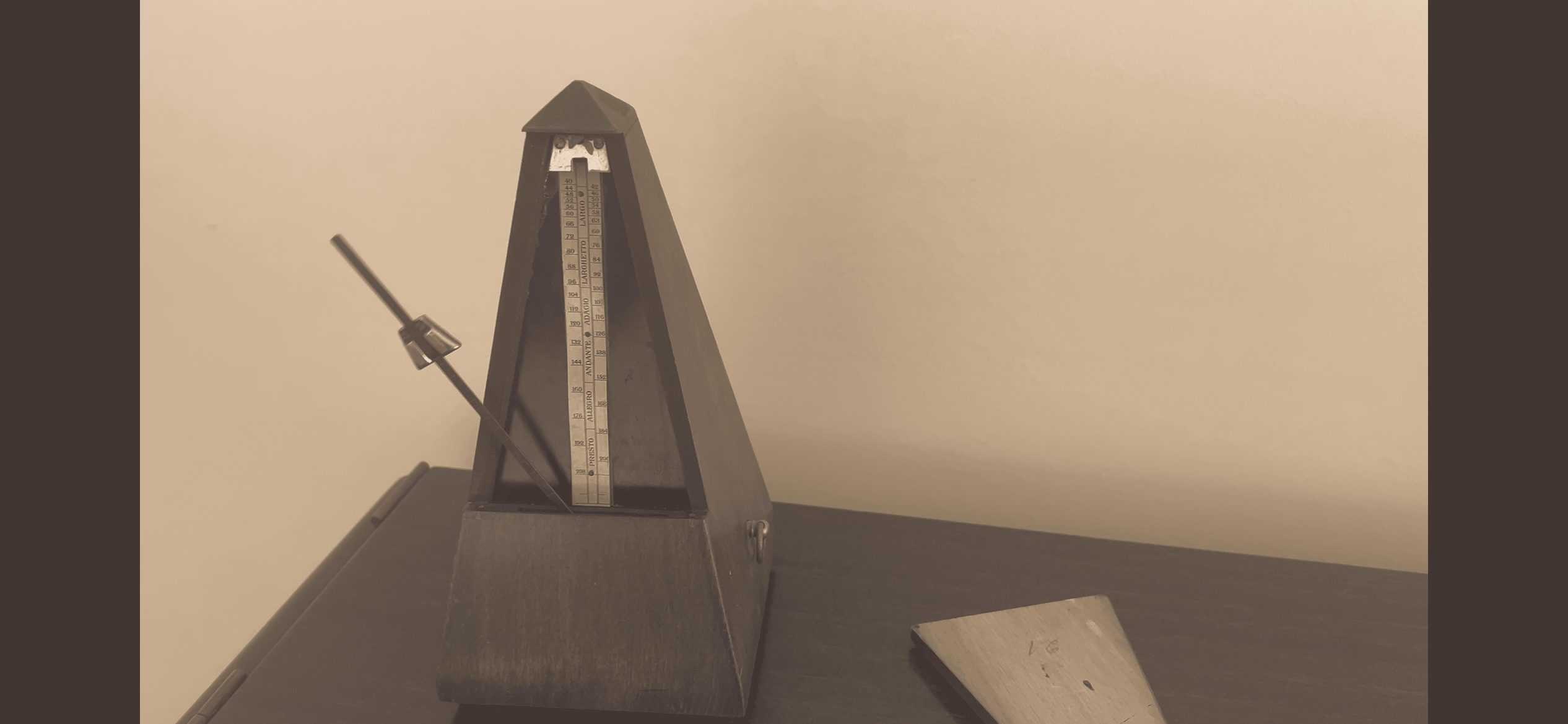 sepia photo of a wooden instrument on a table