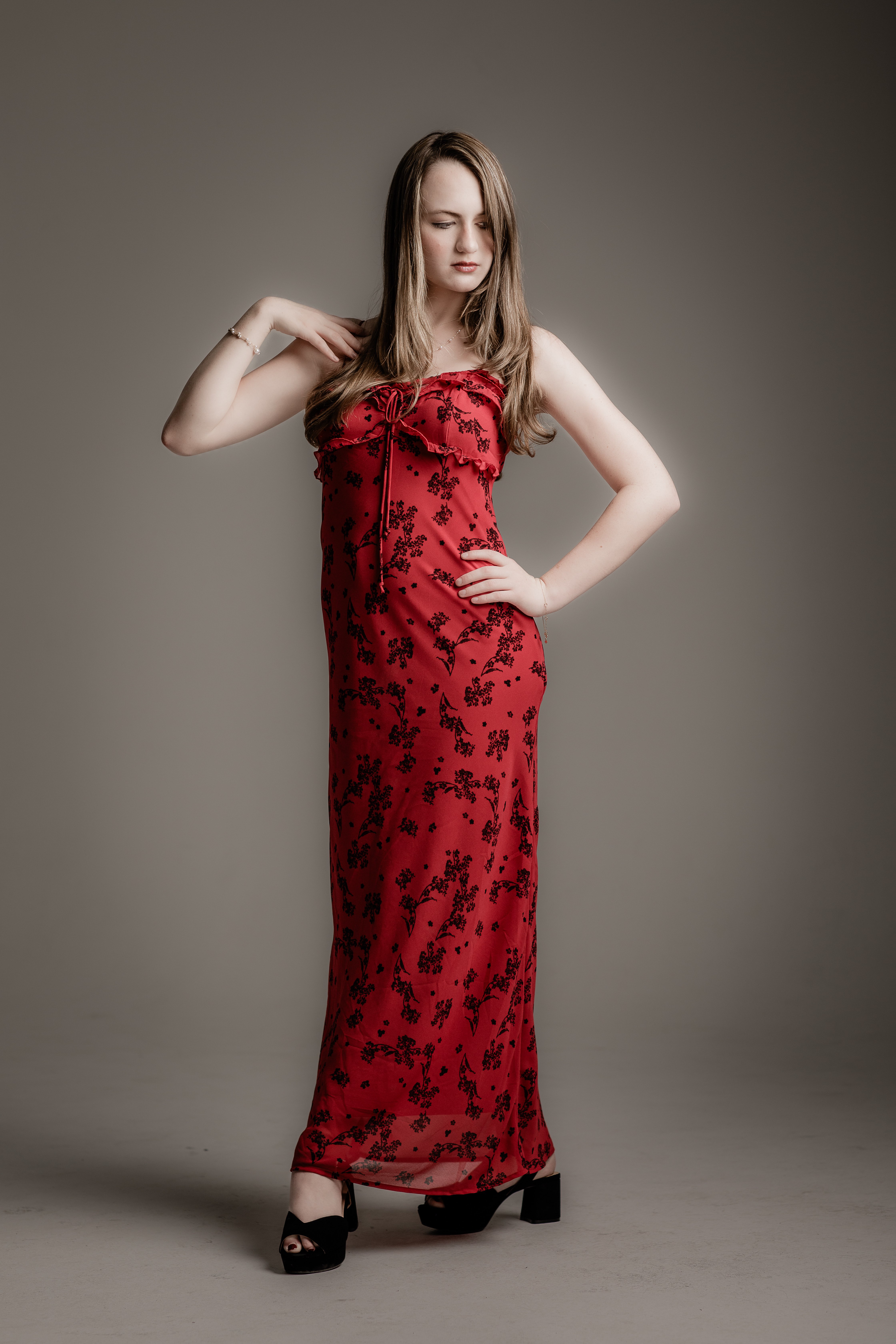 a woman in a red dress posing for a photo