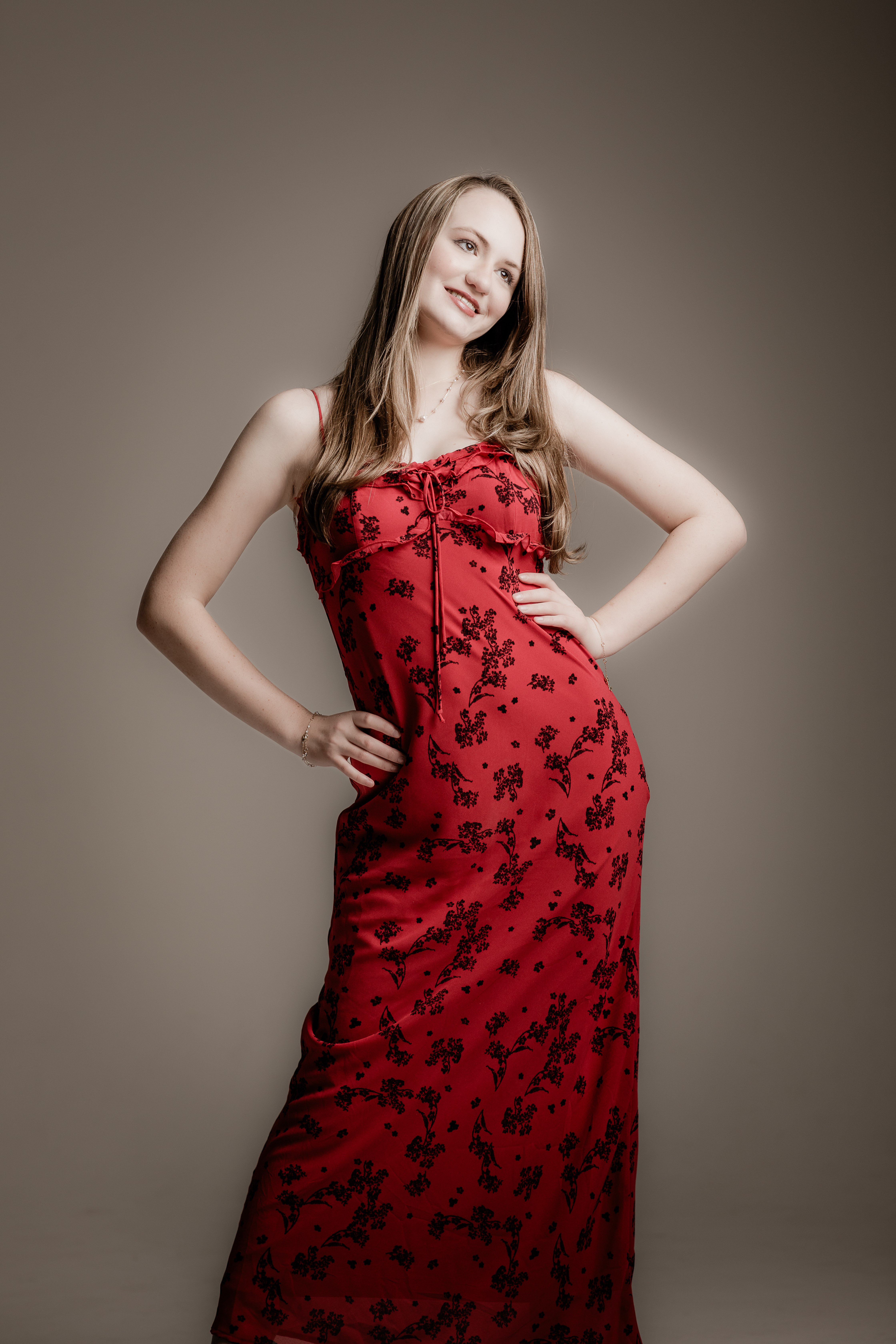 a woman in a red dress posing for a photo