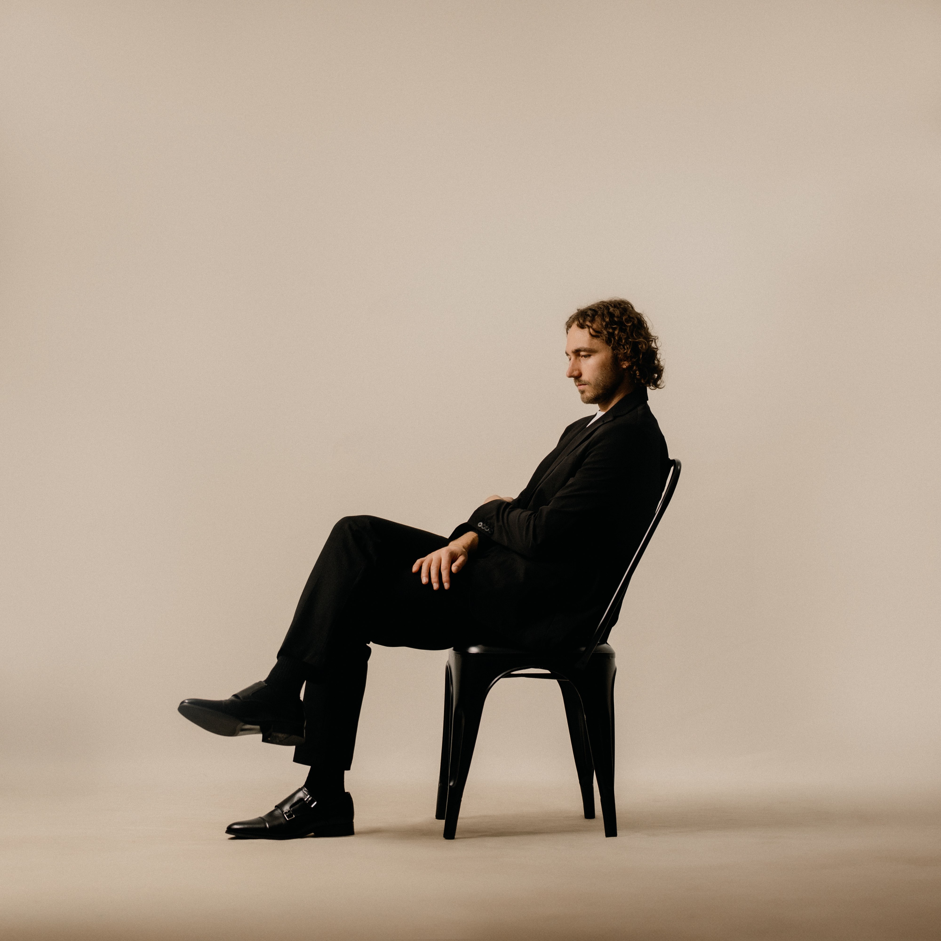 a man in a suit sitting on a chair