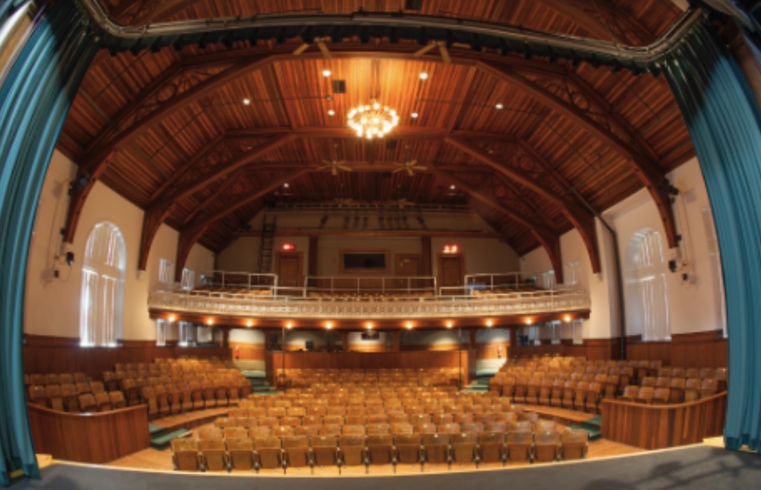a view of an auditorium with wooden seats and a wooden ceiling