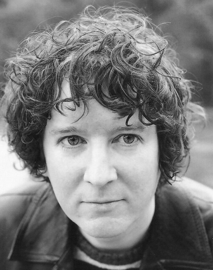 a black and white photo of a woman with curly hair