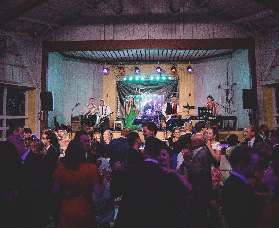a group of people dancing at a wedding reception