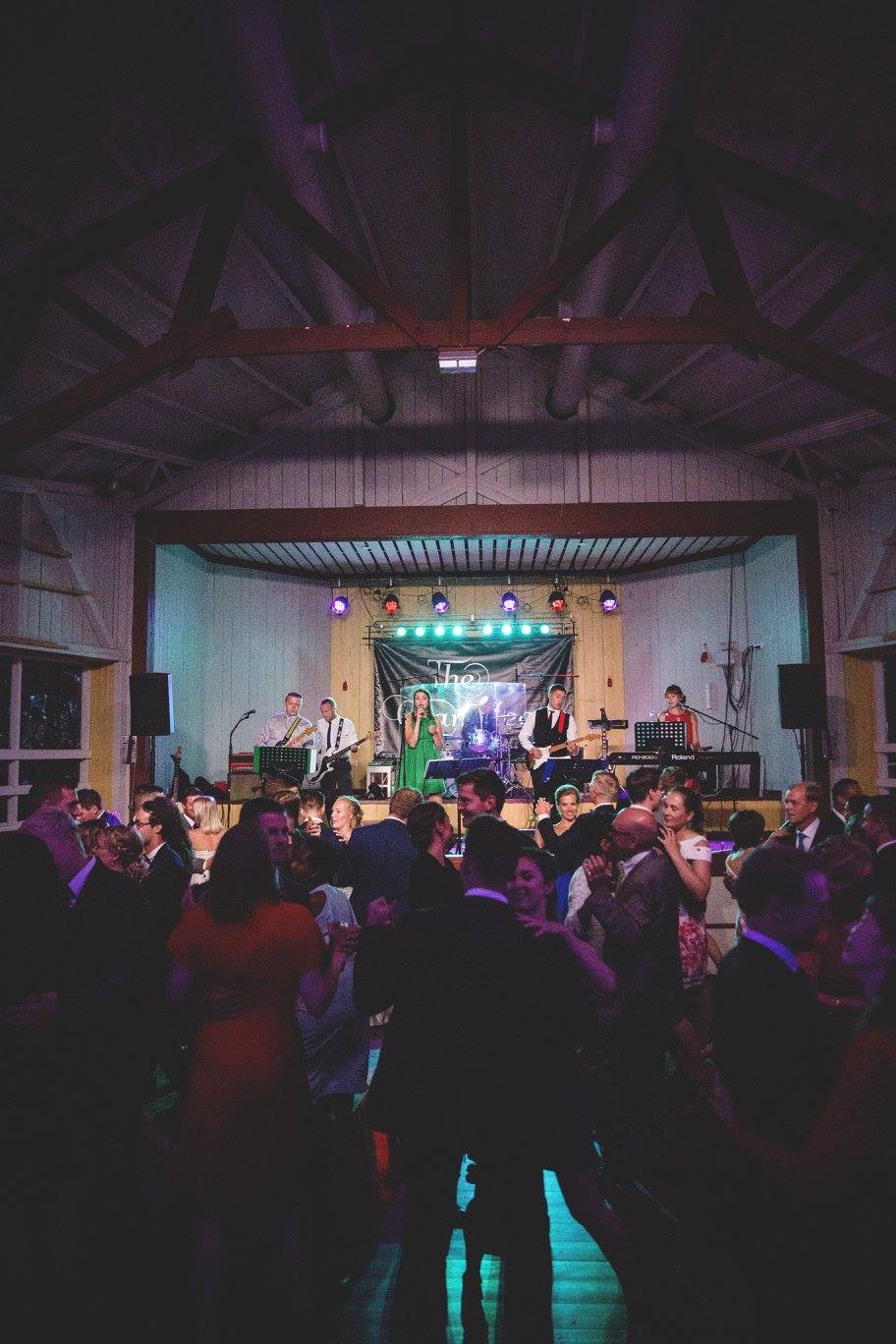 a group of people dancing at a wedding reception