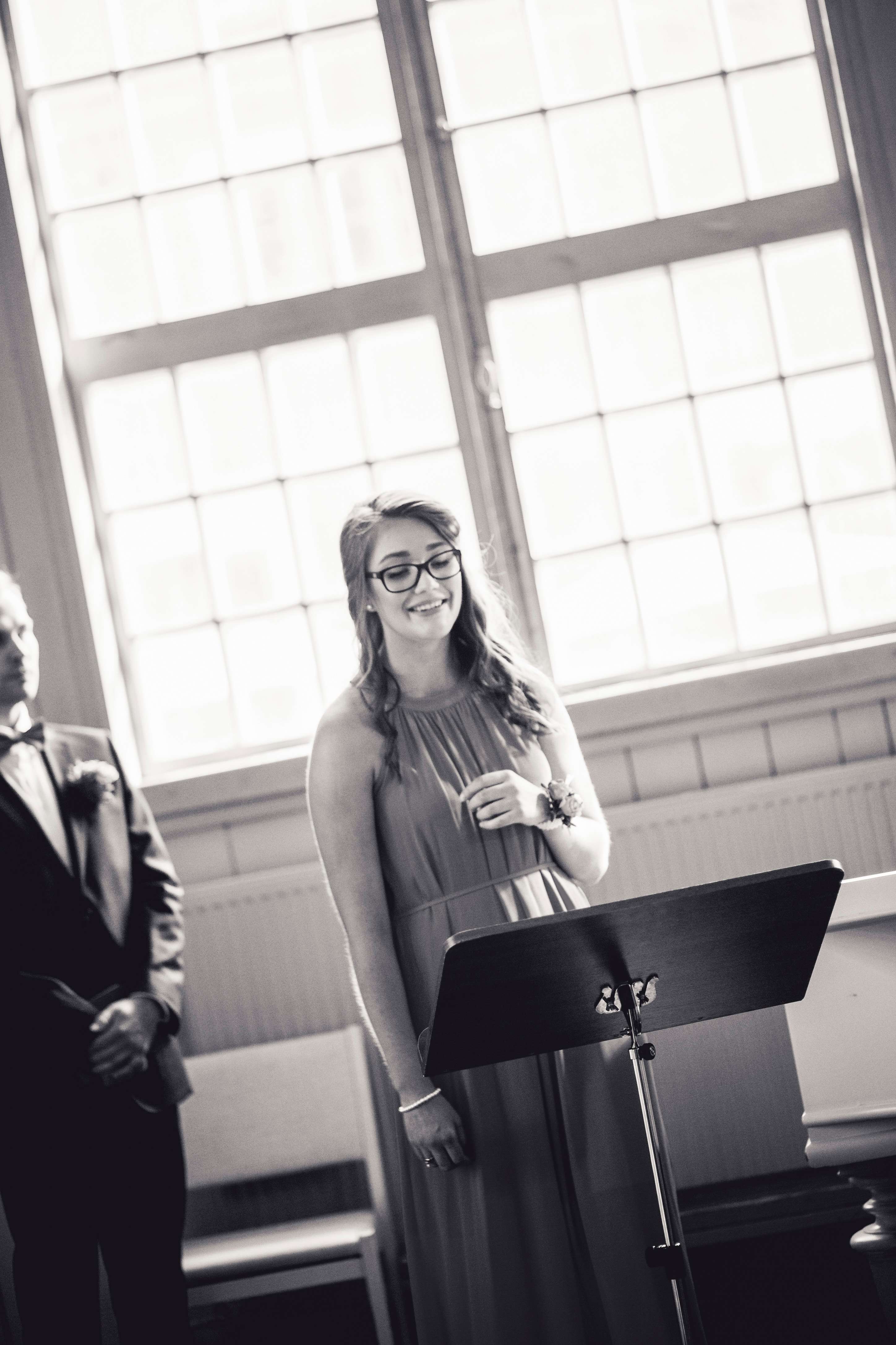 a bride and groom standing in front of a microphone