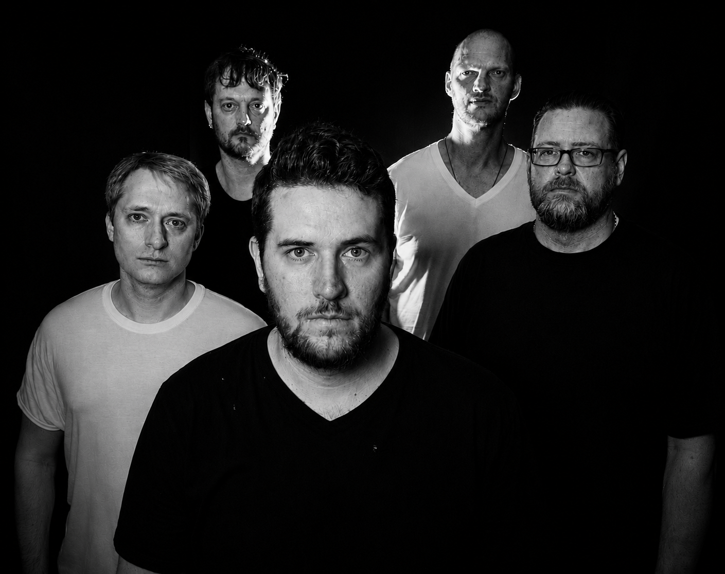 a black and white photo of a group of men
