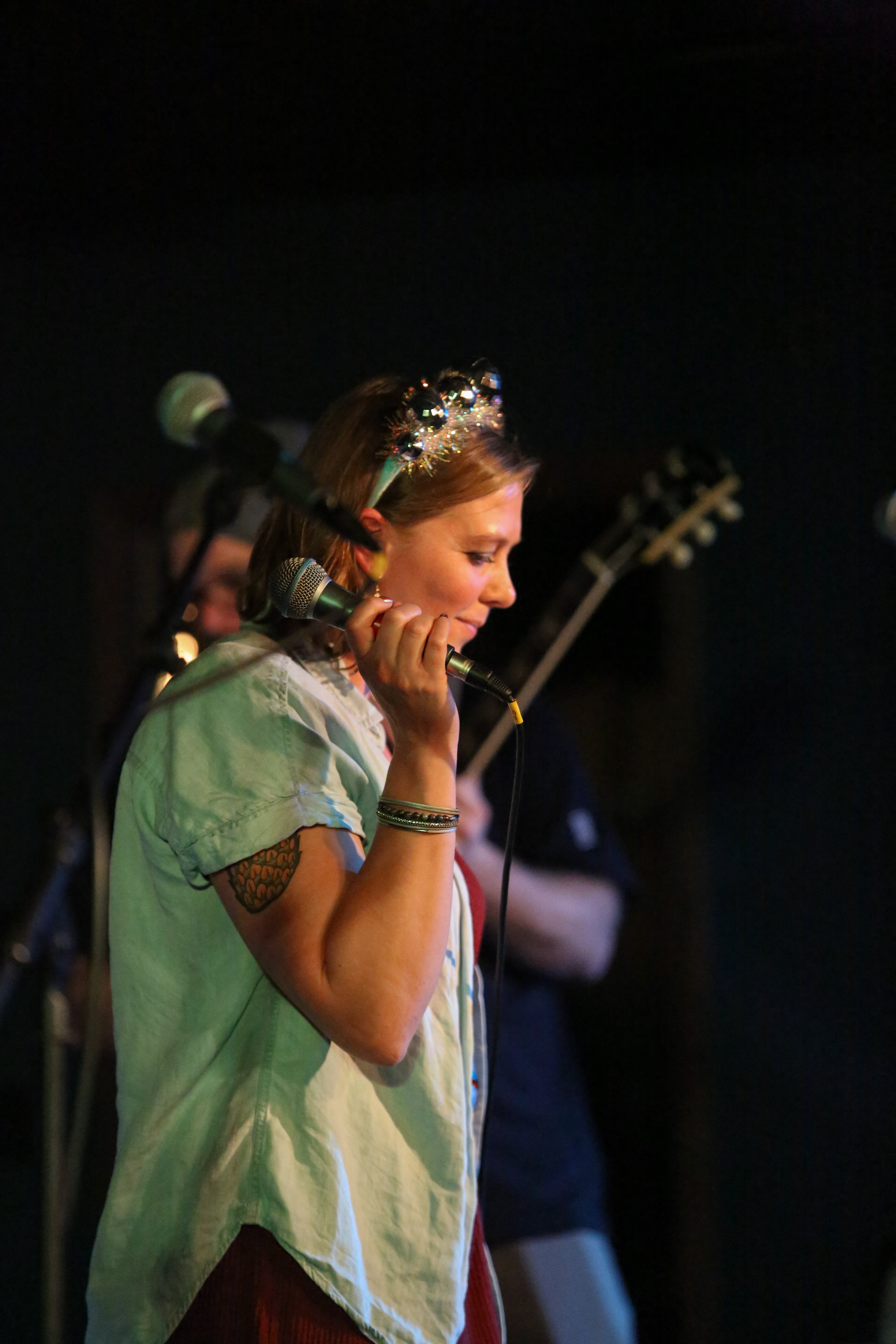 a woman singing into a microphone