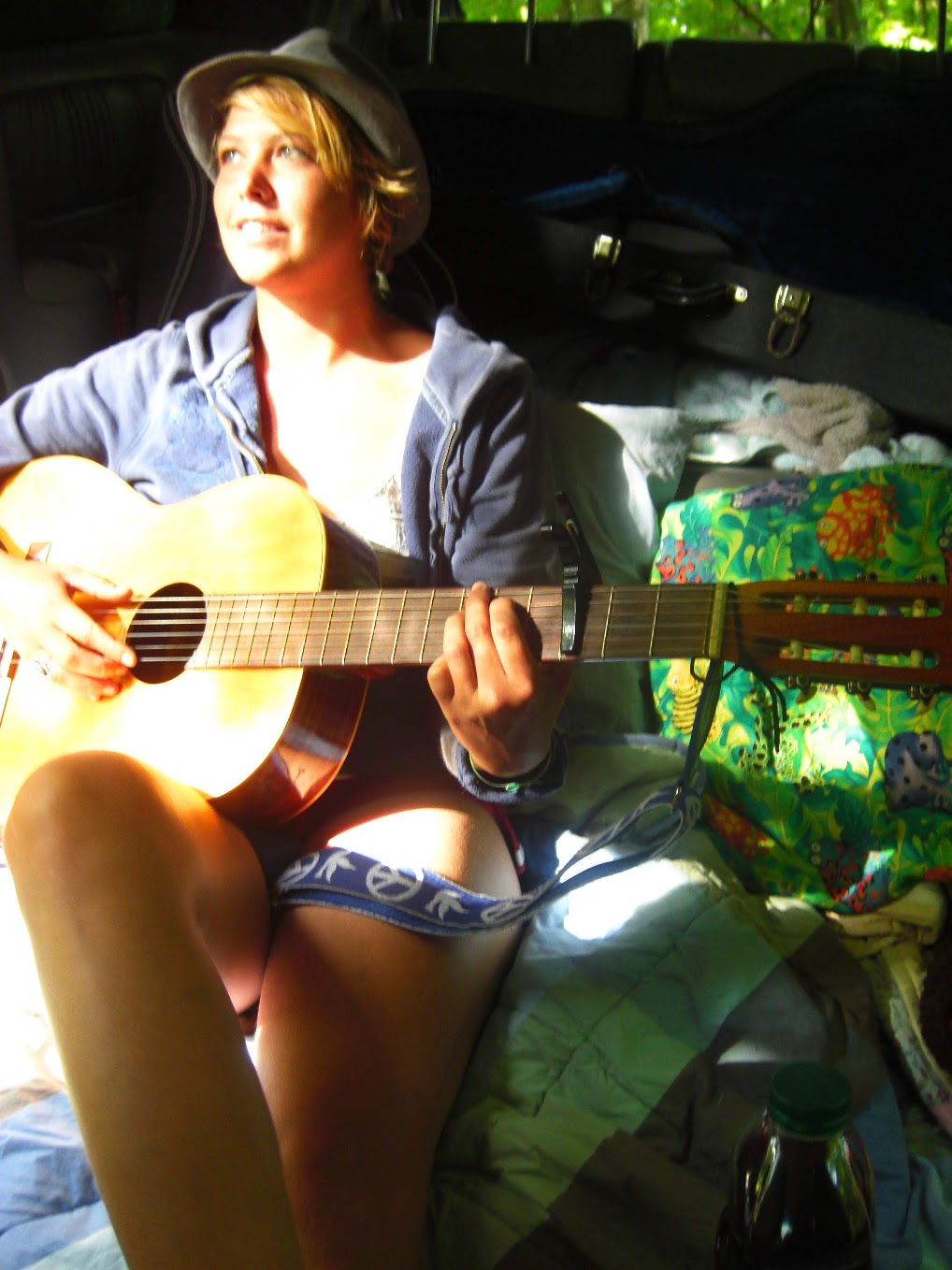 a woman playing an acoustic guitar