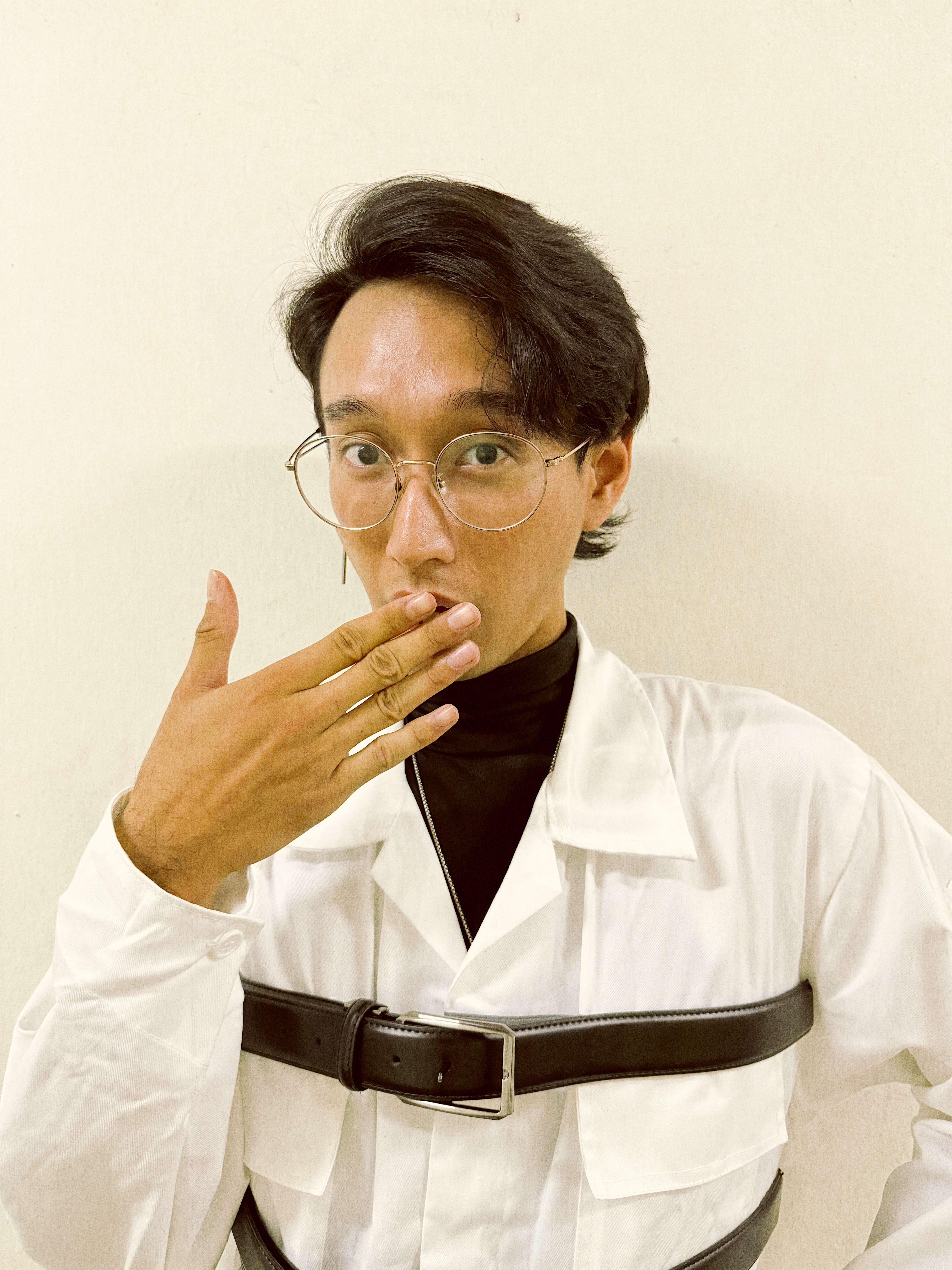 a man wearing a white shirt and suspenders