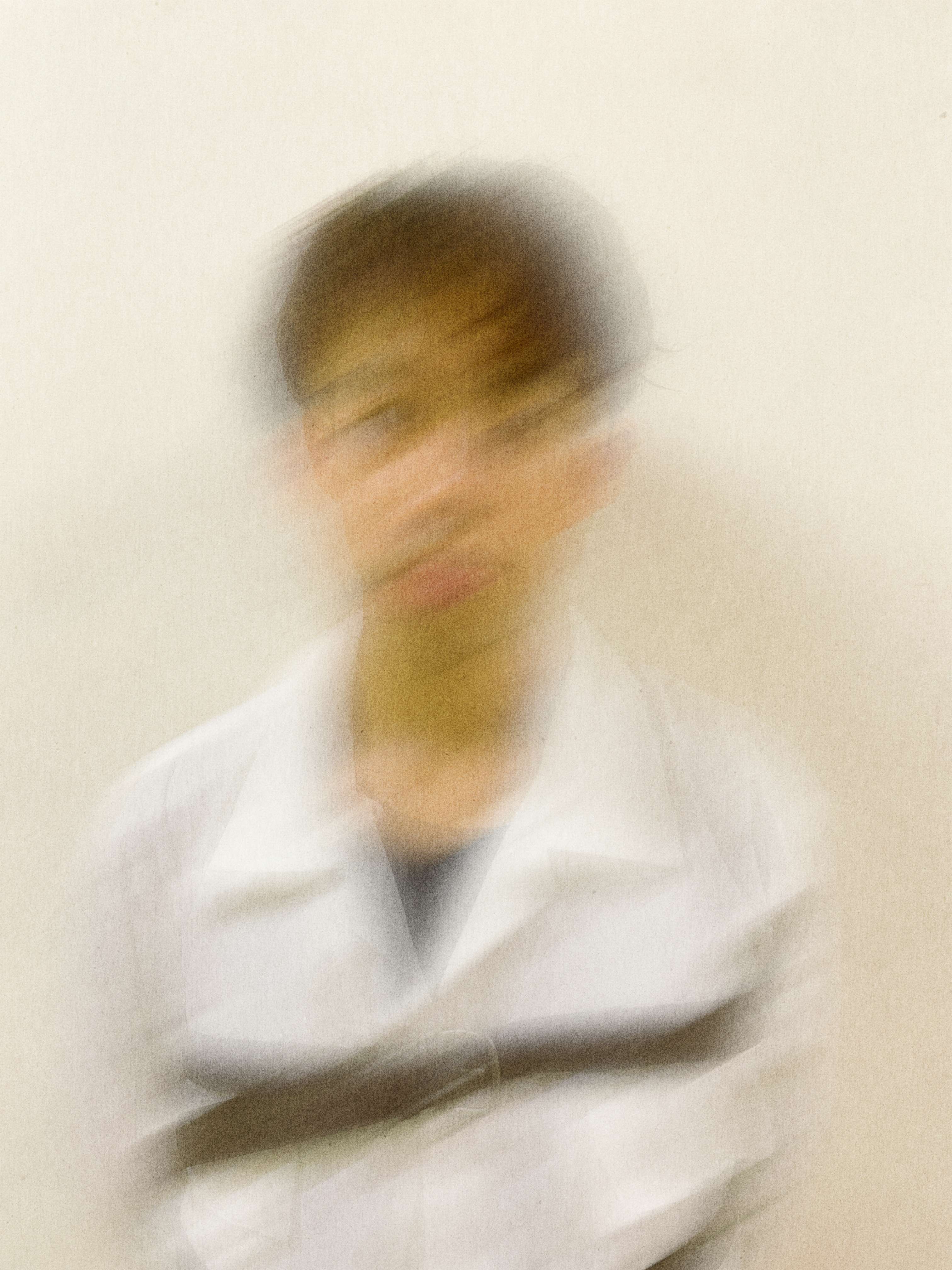 a blurry image of a man in a white shirt