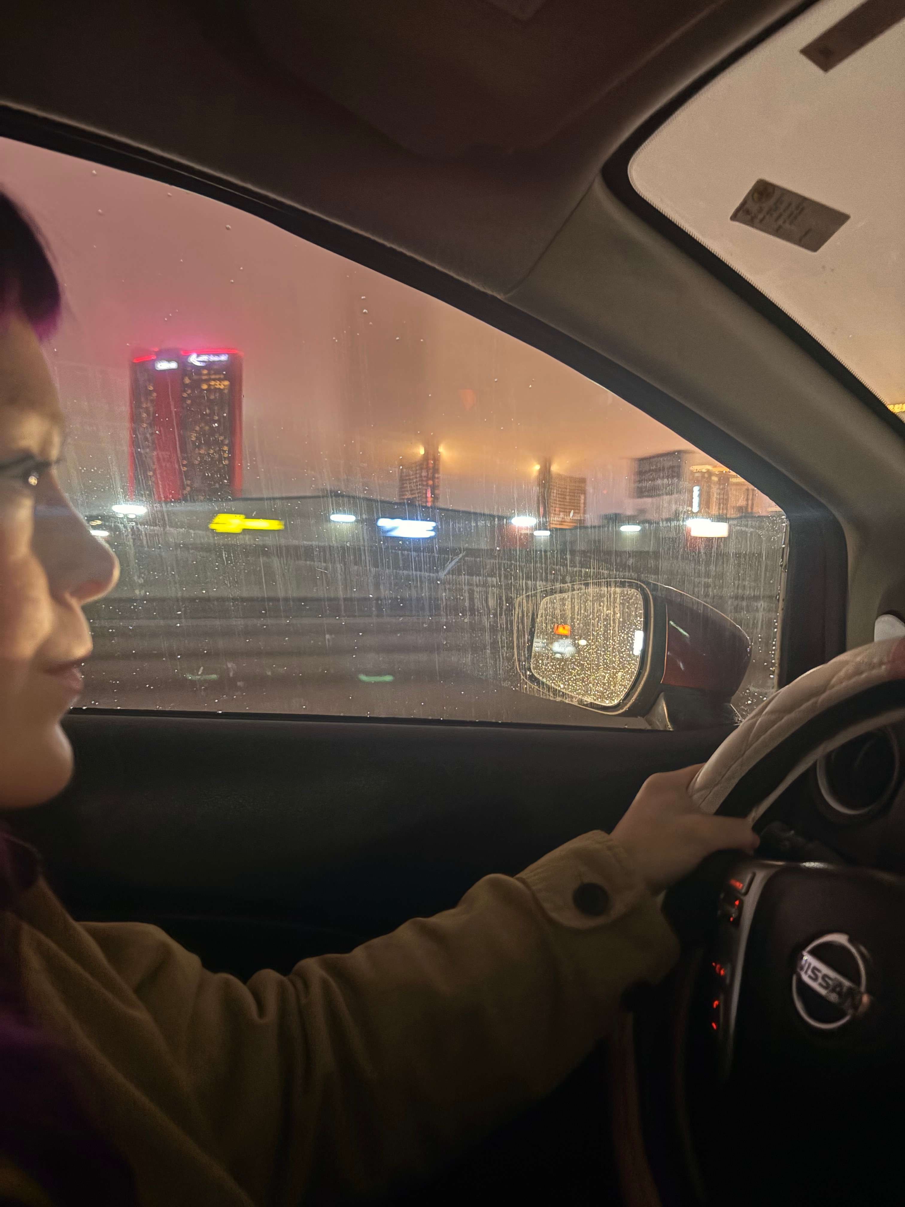 a woman driving a car at night